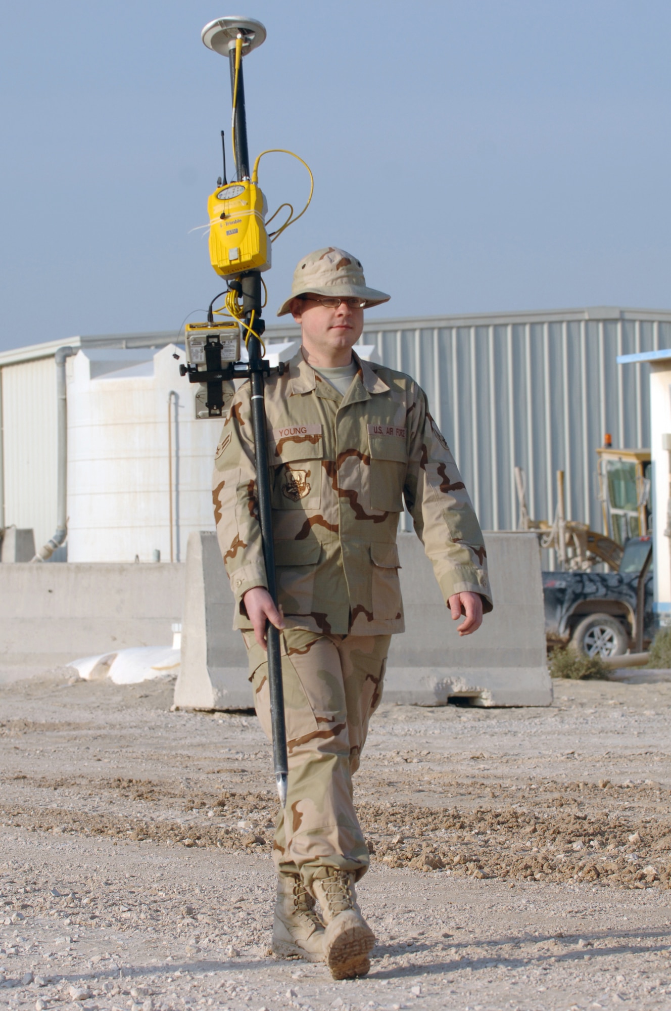 Airman First Class Brian J. Young, 379th Expeditionary Civil Engineer Squadron, prepares a Global Positioning System survey rover to accurately plot unmarked roads for a base map Jan. 17 at a Southwest Asia air base.  Airman Young is deployed here from Ramstein Air Base, Germany.  (U.S. Air Force photo/Tech. Sgt. Johnny L. Saldivar)