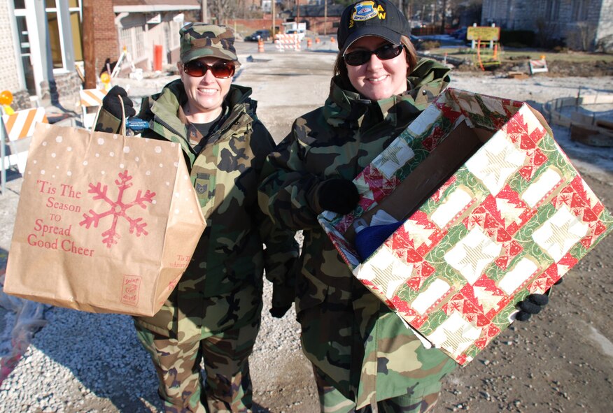 Members of the Air Force Reserve Command's Illinois flying unit, the 932nd Airlift Wing, donate warm hats and gloves to a local women's shelter after collecting items from fellow Reservists.