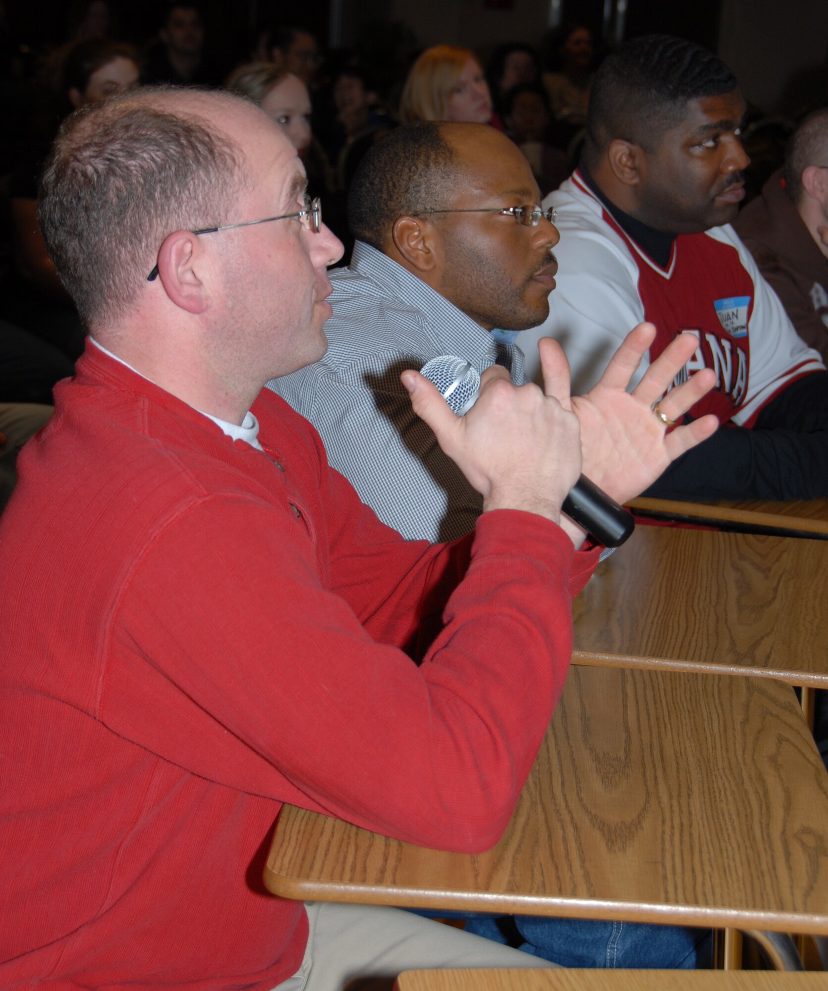 MISAWA AIR BASE, Japan --  Chaplain (Capt.) Mathew Boarts, team captain for Omniscience, answers a fifth grade question, while Army Sgt. Karl Henry, Team Henry captain, and Army Sgt. Dajuan Groves, Team Groves captain, await their turn during the "Are You Smarter Than A 5th Grader" contest at the Mokuteki Community Center Jan. 19, 2008. Omniscience came in first place, Team Henry came in second and Team Groves took third. (U.S. Air Force photo by Staff Sgt. Rachel Martinez) 