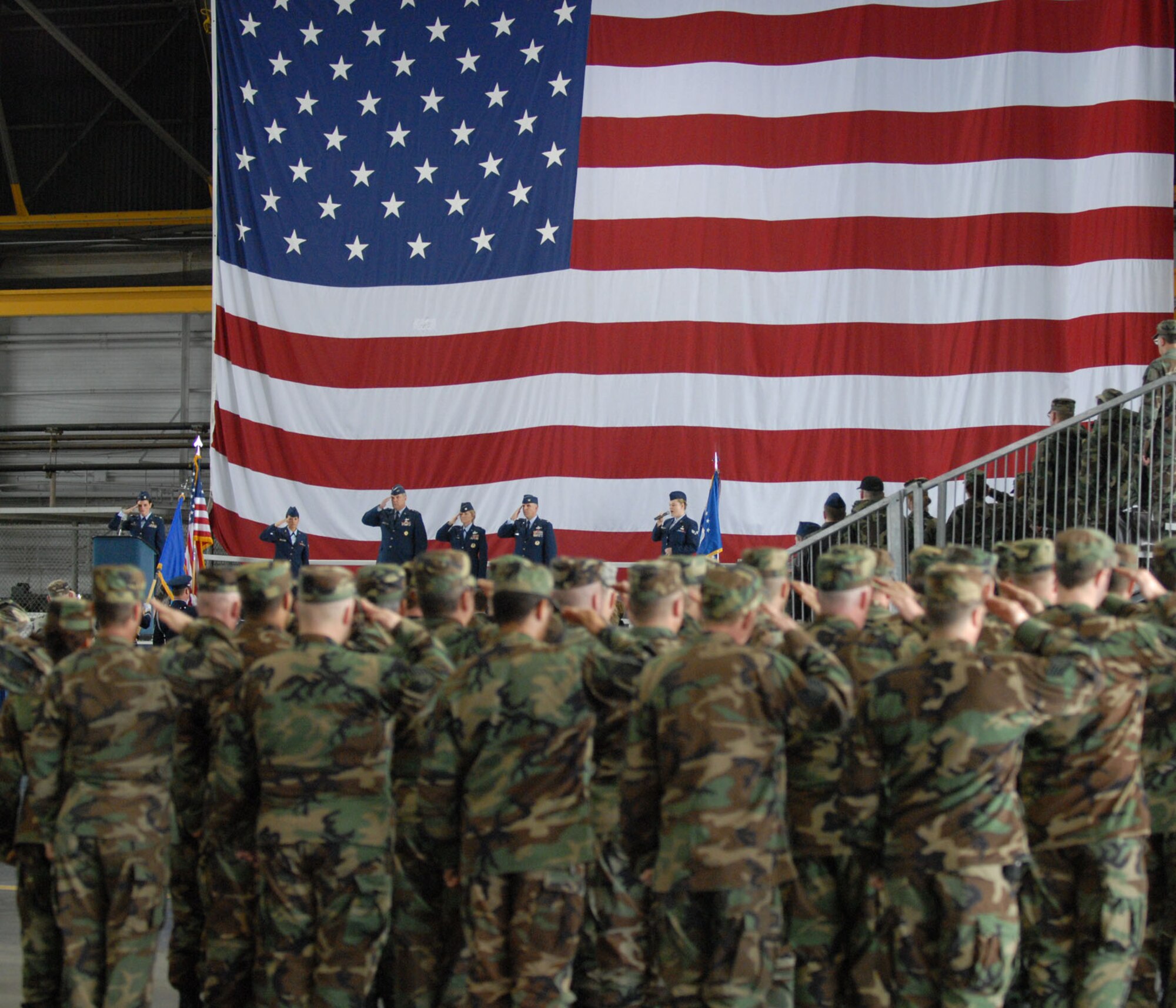 Members of the Air Force Reserve Command's Illinois flying wing, the 932nd Airlift Wing, salute the American flag.  Colonel John (Jay) C. Flournoy, Jr. is the new commander.  His arrival at Scott AFB is a homecoming of sorts. His father was assigned to the southern Illinois base three times. "When asked where I'm from, I tell people I was born in Alabama, but I consider Scott AFB my home town," said Colonel Flournoy. Throughout those assignments, he attended Scott AFB elementary schools and Mascoutah High School in Mascoutah, Ill., for much of his early life. He graduated from Southern Illinois University at Edwardsville, Ill., where he also graduated from the Reserve Officer Training Corps. He entered the Air Force in 1986. 

While on active duty, he served as a B-52 pilot and as a T-37 instructor pilot. He joined the Air Force Reserve in 1991 as an HH-60G Blackhawk helicopter pilot and became an Air Reserve Technician in 1994. Colonel Flournoy returned to active duty in July of 1999 where he served in the Reserve Operations and Requirements Division, as well as the Reserve Studies and Programs Division of the Air Staff. 

Following his tour at the Pentagon he attended National War College at the National Defense University in Washington D.C. Colonel Flournoy was deployed as Operations Group Commander of the 386th EOG Ali Al Salem, Kuwait. 