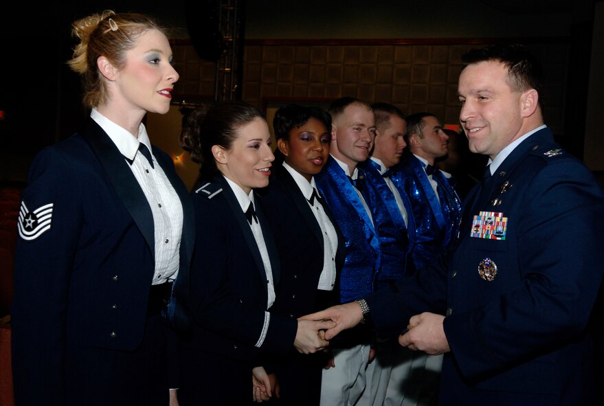 FAIRCHILD AIR FORCE BASE, Wash. –Col. Thomas Sharpy, 92nd Air Refueling Wing commander, presents the members of Tops in Blue with coins after their performance near Fairchild on Jan 17. Tops in Blue is an all active-duty special unit comprised of 35 talented vocalists, musicians and dancers. (U.S. Air Force photo/Airman 1st Class Darlene West) 