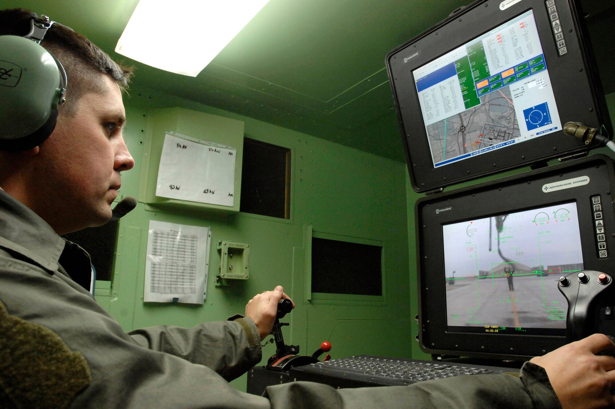 Royal Air Force officer Maj. Kevin Gambold monitors and pilots an MQ-1 Predator unmanned aerial vehicle following a mission Jan. 10 at Ali Base, Iraq. Major Gambold, who is part of a military personnel exchange program and is assigned to the 15th Reconnaissance Squadron, Creech Air Force Base, Nev., is currently deployed to the 361st Expeditionary Reconnaissance Squadron at Ali Base as the squadron commander. (U.S. Air Force photo/Airman 1st Class Jonathan Snyder) 