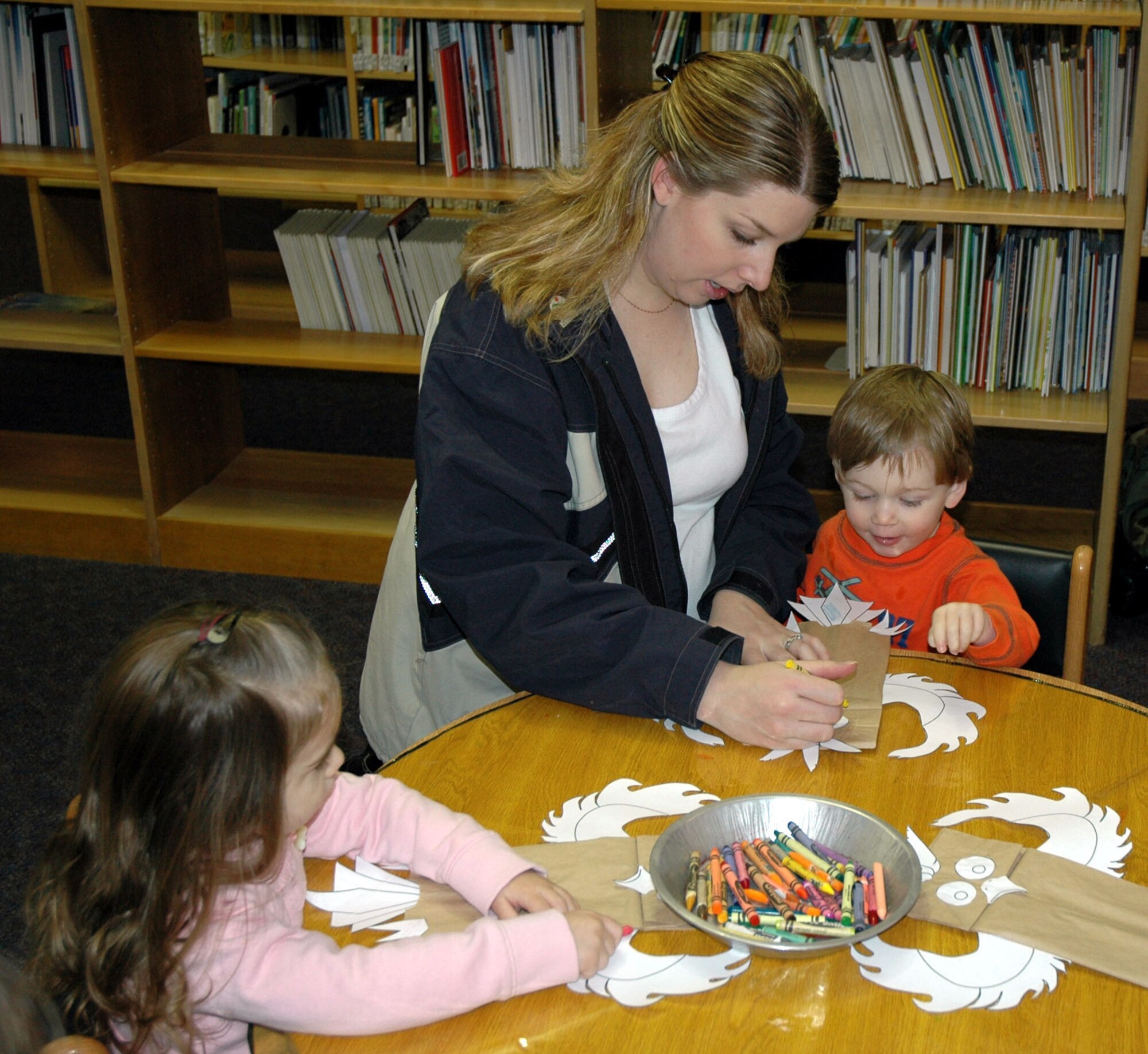 Nicki Hope helps her son, Jayden, 2, color his owl-themed craft project Jan. 22 at the Arden G. Hill Memorial Library, while Little Warrior Annika, 2 ½, looks on and creates her own art project. Each Tuesday at 10 a.m., the library holds storytime and the children create craft projects that coincide with the day’s reading theme. Check out other library events at www.341services.com/library. (U.S. Air Force photo/Senior Airman Eydie Sakura)