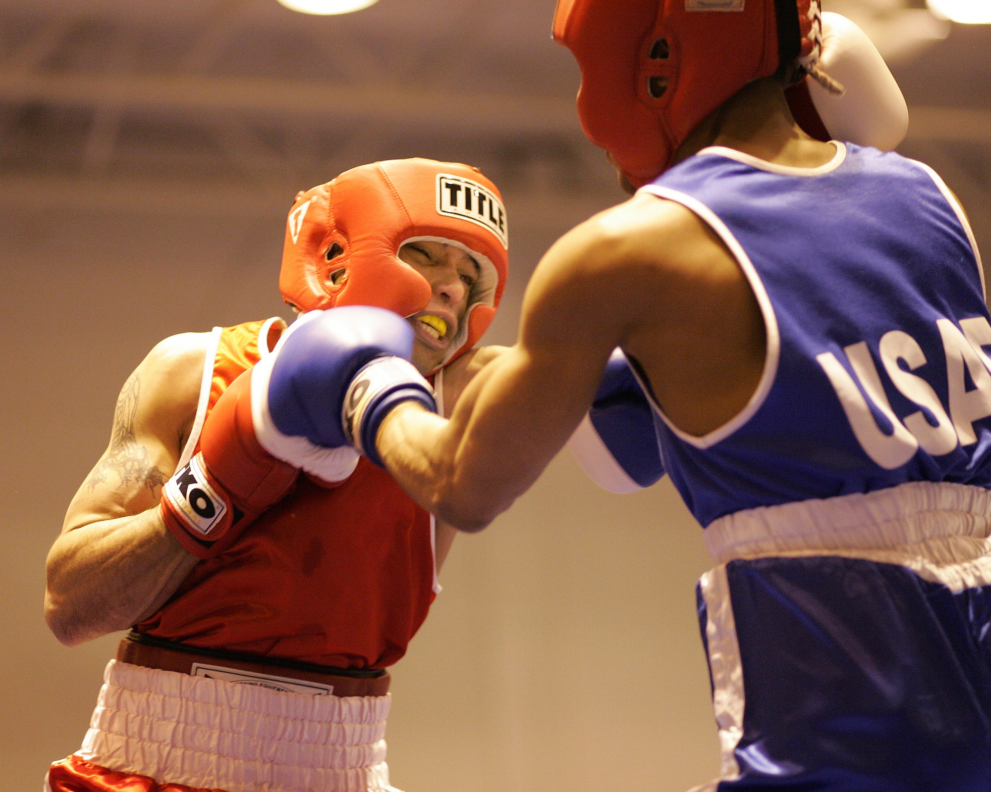 Rosey Summerville from Shaw Air Force Base, S.C., moves in to punch Chance Yearwood from Charleston AFB, S. C. The boxers competed in the Air Force Box-Off at the Bennett Fitness Center at Lackland AFB, Texas, Jan. 19. Summervile won the match. (U.S. Air Force photo/Robbin Cresswell) 