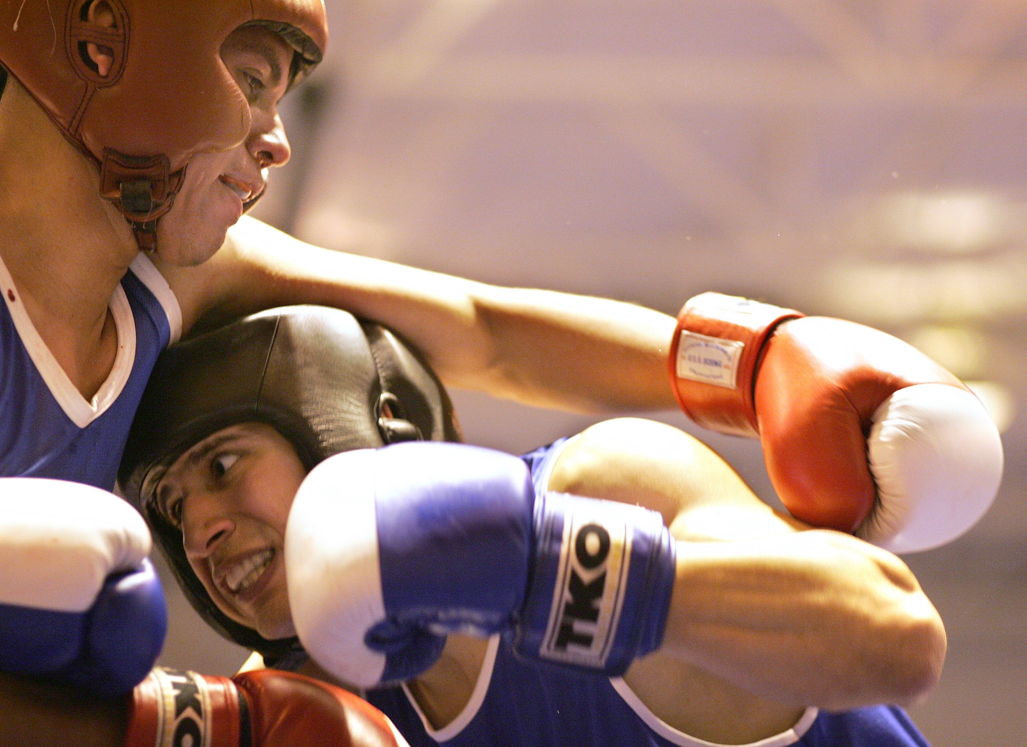 Anthony Jones ducks under the arm of Raul Romero during the Air Force Box-Off at the Bennett Fitness Center Jan. 19 at Lackland Air Force Base, Texas . Jones won the bout in the first round with a "referee stopped the contest" decision. (U.S. Air Force photo/Robbin Cresswell) 
