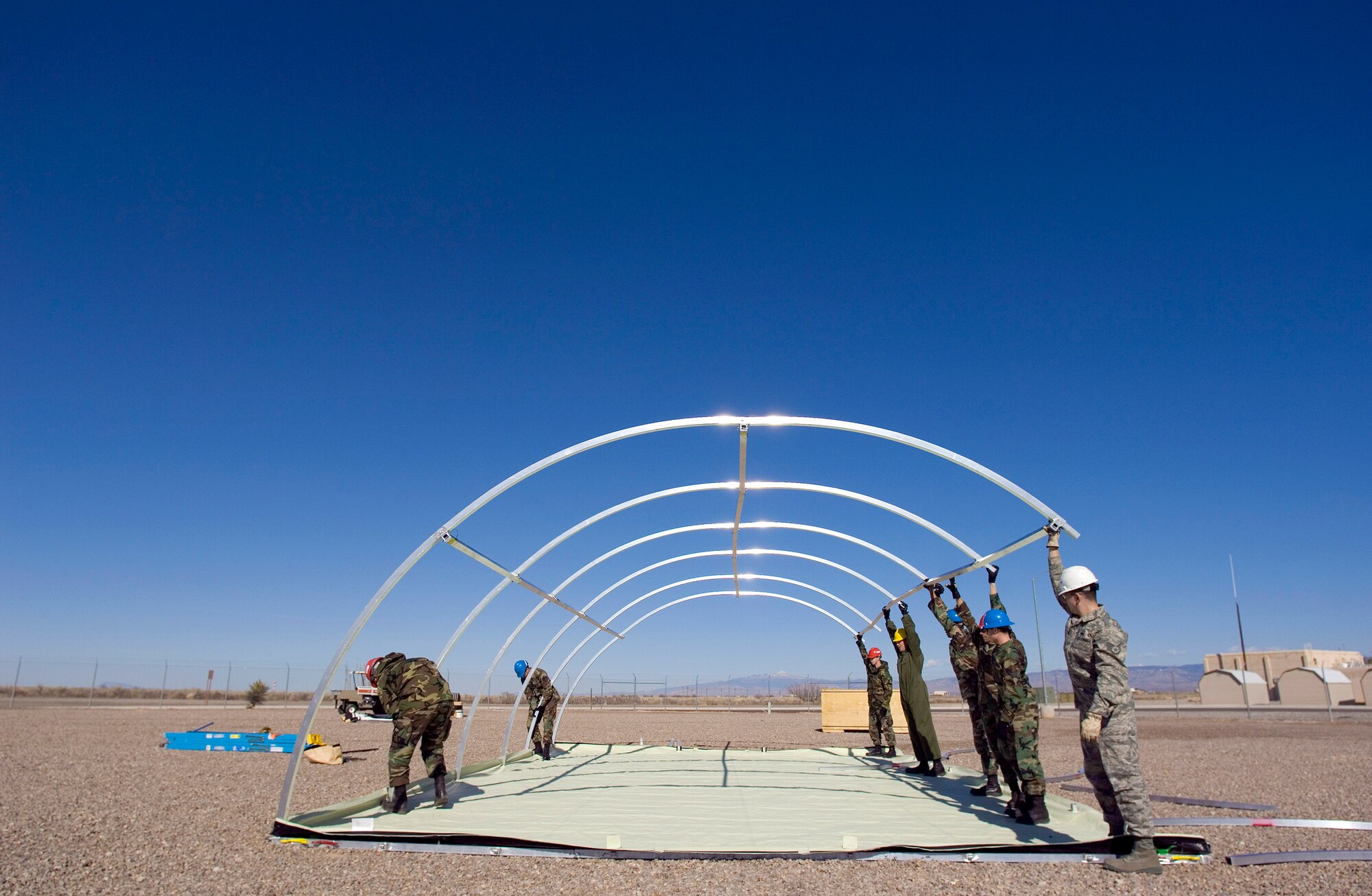 Airmen from the 49th Material Maintenance Group work to build a small shelter system during a Jan. 16 exercise at Holloman Air Force Base, N.M. Members of the 49th MMG can build a Basic Expeditionary Airfield Resource, or BEAR, in austere conditions anywhere in the world. Airmen of the 49th MMG maintain a constant state of readiness and can be tasked to support any Department of Defense or Federal Emergency Management Agency humanitarian operations along with primary duties of supporting combat operations. (U.S. Air Force photo/Staff Sgt. Bennie J. Davis III) 

