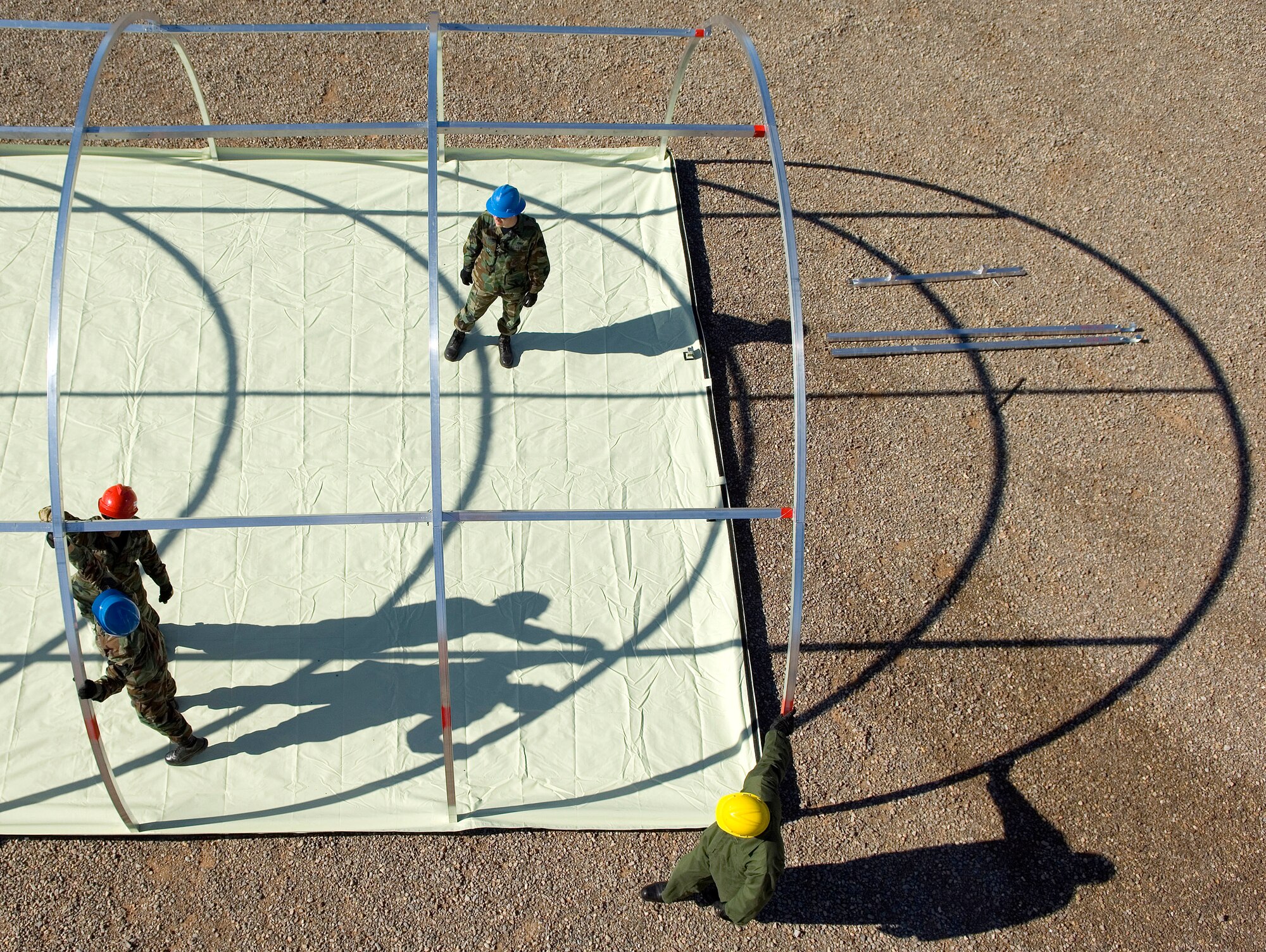 Airmen from the 49th Material Maintenance Group work to build a small shelter system during a Jan. 16 exercise at Holloman Air Force Base, N.M. Members of the 49th MMG can build a Basic Expeditionary Airfield Resource, or BEAR, in austere conditions anywhere in the world. Airmen of the 49th MMG maintain a constant state of readiness and can be tasked to support any Department of Defense or Federal Emergency Management Agency humanitarian operations along with primary duties of supporting combat operations. (U.S. Air Force photo/Staff Sgt. Bennie J. Davis III) 

