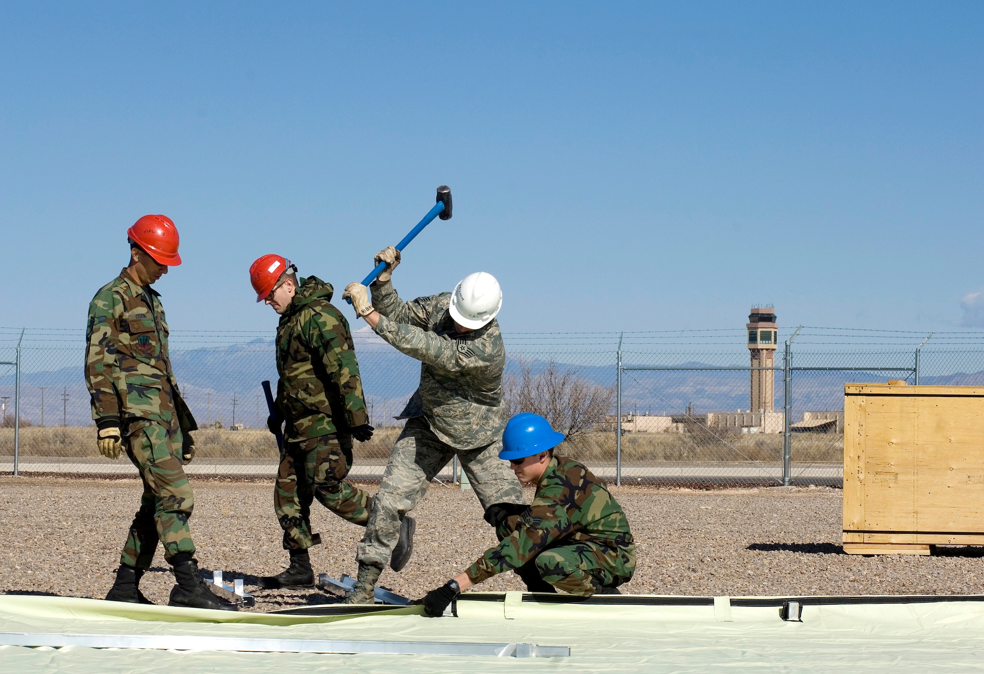 Airmen from the 49th Material Maintenance Group work to build a small shelter system during a Jan. 16 exercise at Holloman Air Force Base, N.M. Members of the 49th MMG can build a Basic Expeditionary Airfield Resource, or BEAR, in austere conditions anywhere in the world. Airmen of the 49th MMG maintain a constant state of readiness and can be tasked to support any Department of Defense or Federal Emergency Management Agency humanitarian operations along with primary duties of supporting combat operations. (U.S. Air Force photo/Staff Sgt. Bennie J. Davis III) 

