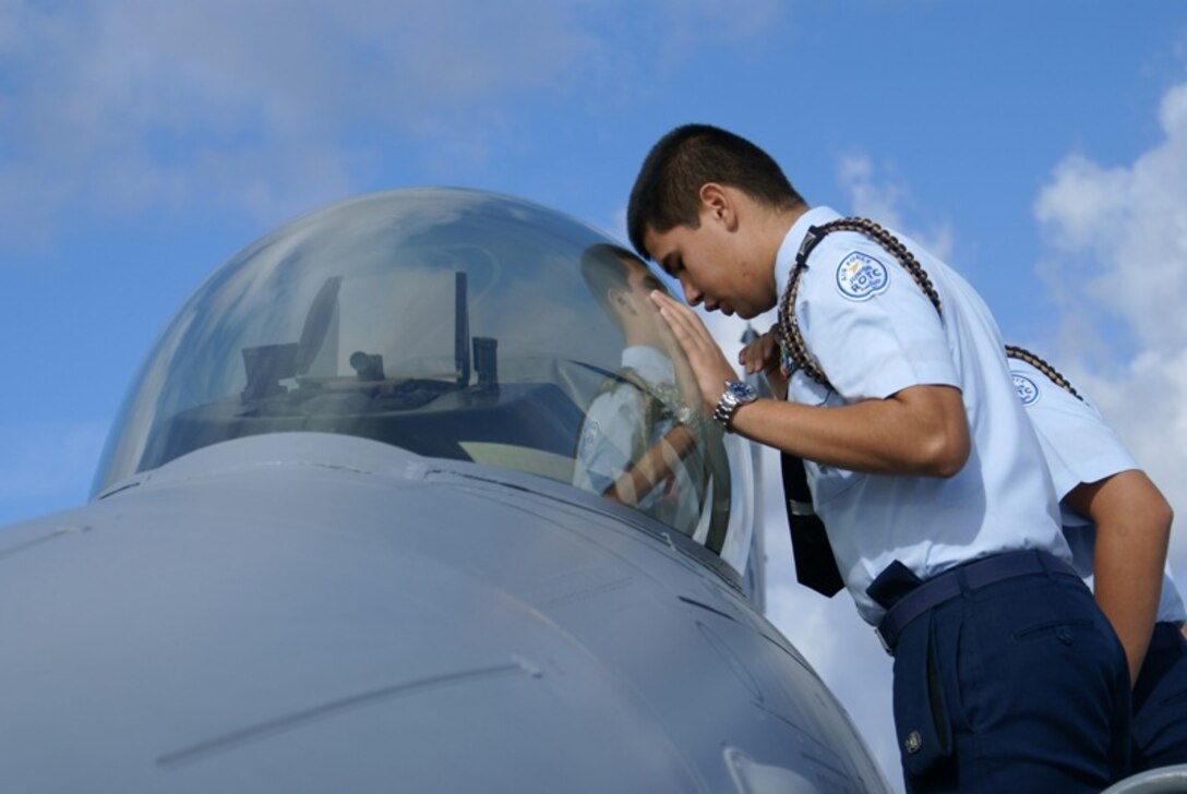 A Hialeah High School Air Force Junior ROTC cadet gazes into the cockpit of an F-16 fighter jet during a tour of Homestead Air Reserve Base on Jan. 11. About 35 students got a first-hand view of the jets, received a briefing from a pilot, security forces personnel, Air Force Reserve Recruiters, and toured the aircraft control tower and fire station. Homestead ARB offers two tours each month for students or community organizations. (U.S. Air Force photo/Senior Airman Erik Hofmeyer)