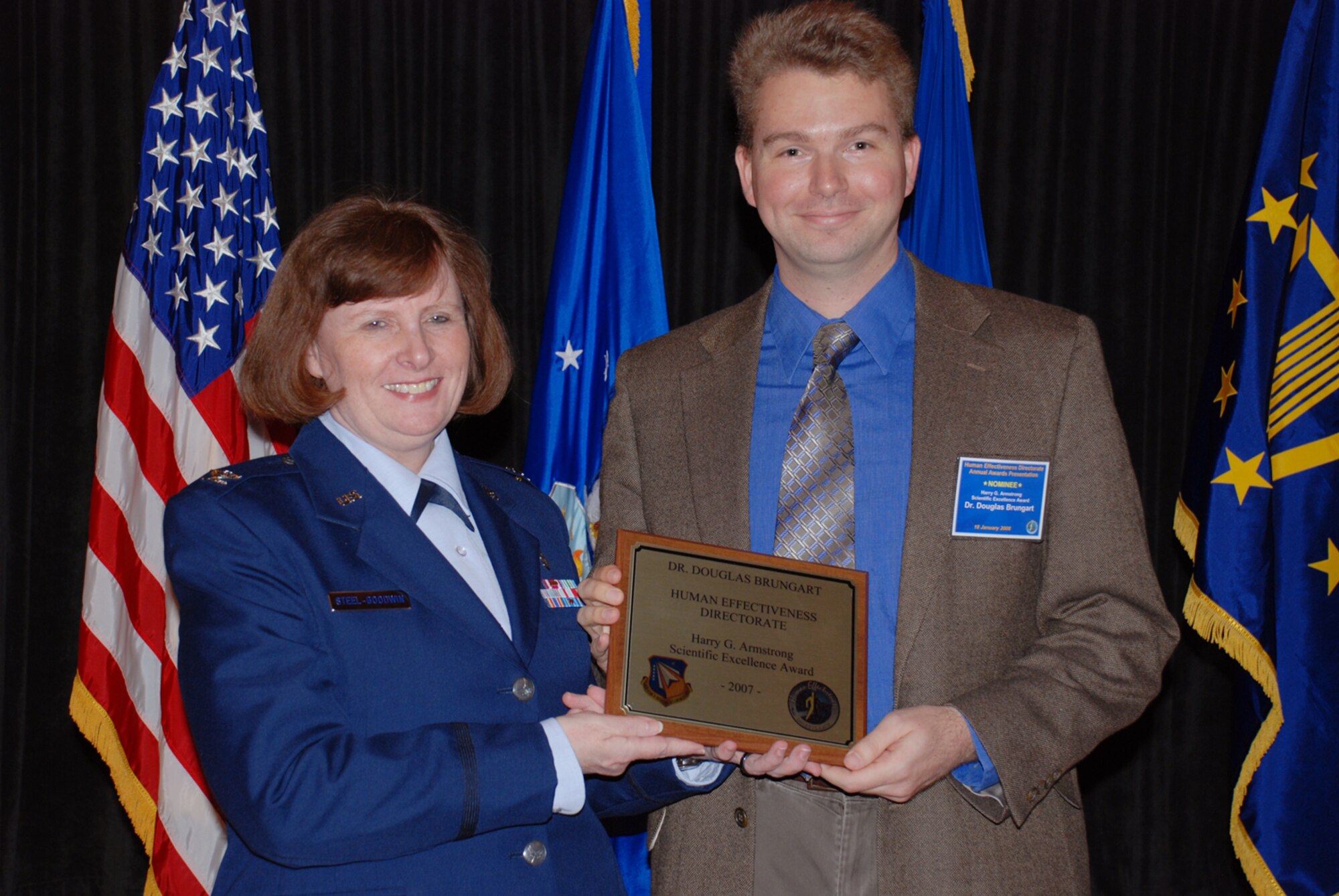 Colonel Linda Steel-Goodwin (left), deputy director of the Air Force Research Laboratory’s Human Effectiveness Directorate (AFRL/RH), presents the Harry G. Armstrong Award to 2007 winner Dr. Douglas Brungart, principal computer engineer with AFRL/RH’s Warfighter Interface Division, Battlespace Acoustics Branch, January 18 at the directorate’s annual awards luncheon. (Photo by Chris Gulliford, AFRL/RH)