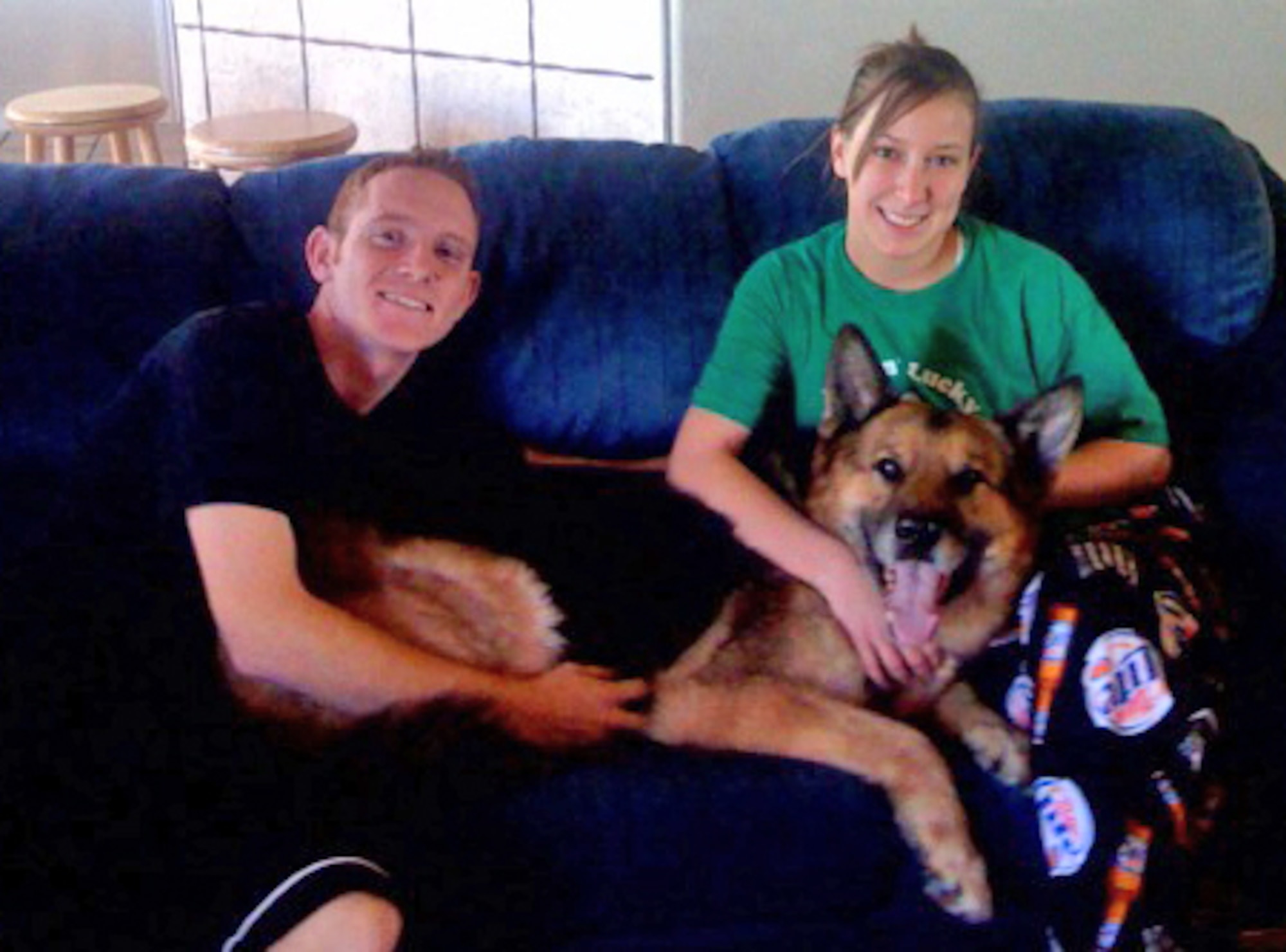 EIELSON AIR FORCE BASE, Alaska--Staff Sgt. Timothy and Airman 1st Class Ashli McEntee take a break with newly-adopted, former military working dog, Sorbon A333 in mid-January. Sergeant McEntee was Sorbon's mwd handler while stationed at Eielson; he and his wife adopted Sorbon Jan. 11. (courtesy photo)