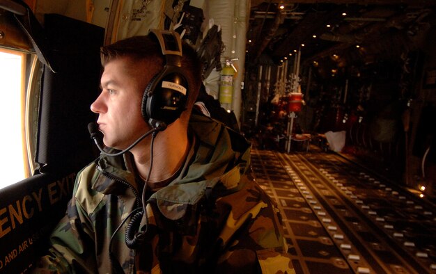 Tech. Sgt. Kyle Gurnon takes a seat next to the rear cargo door of a C-130  Hercules while taxiing for departure Jan. 9 at Ramstein Air Base, Germany, January, 9. Sergeant Gurnon is a Rhode Island Air National Guard loadmaster with the 143rd Airlift Wing at Quanset State Airport. (U.S. Air Force photo/Master Sgt. Scott Wagers) 

