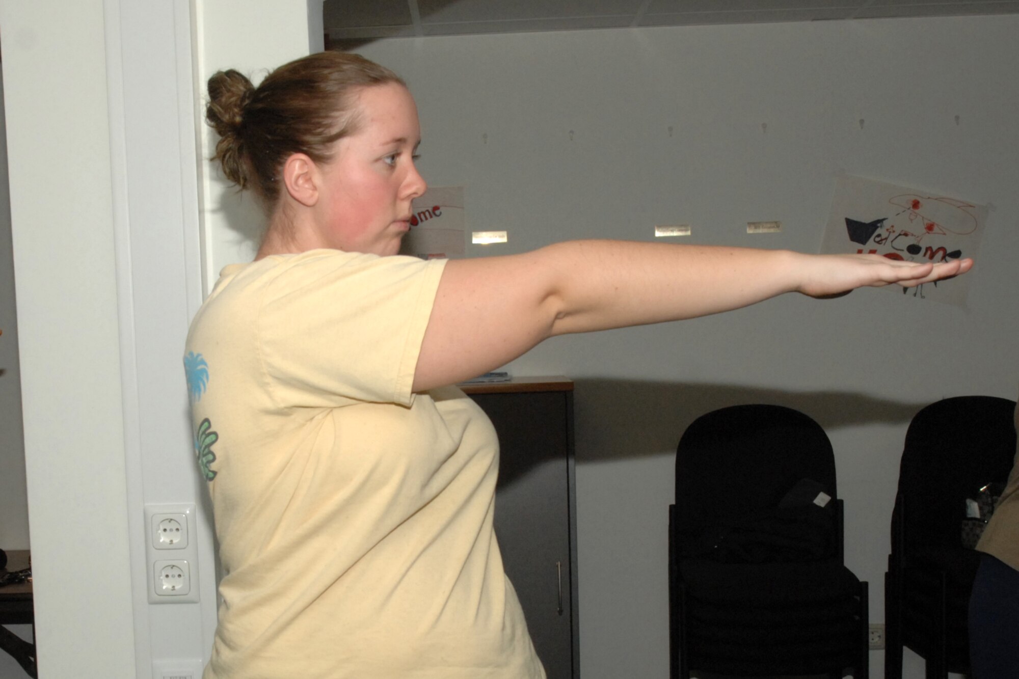 SPANGDAHLEM AIR BASE, Germany -- Amanda Schrader, wife of Airman 1st Class Christopher Schrader, 81st Fighter Squadron, demonstrates a yoga pose during the Protestant Women of the Chapel’s Christian Alternative Yoga Class Jan. 17, 2008. The free class is followed by a bible study. (U.S. Air Force photo/Airman 1st Class Jenifer Calhoun)