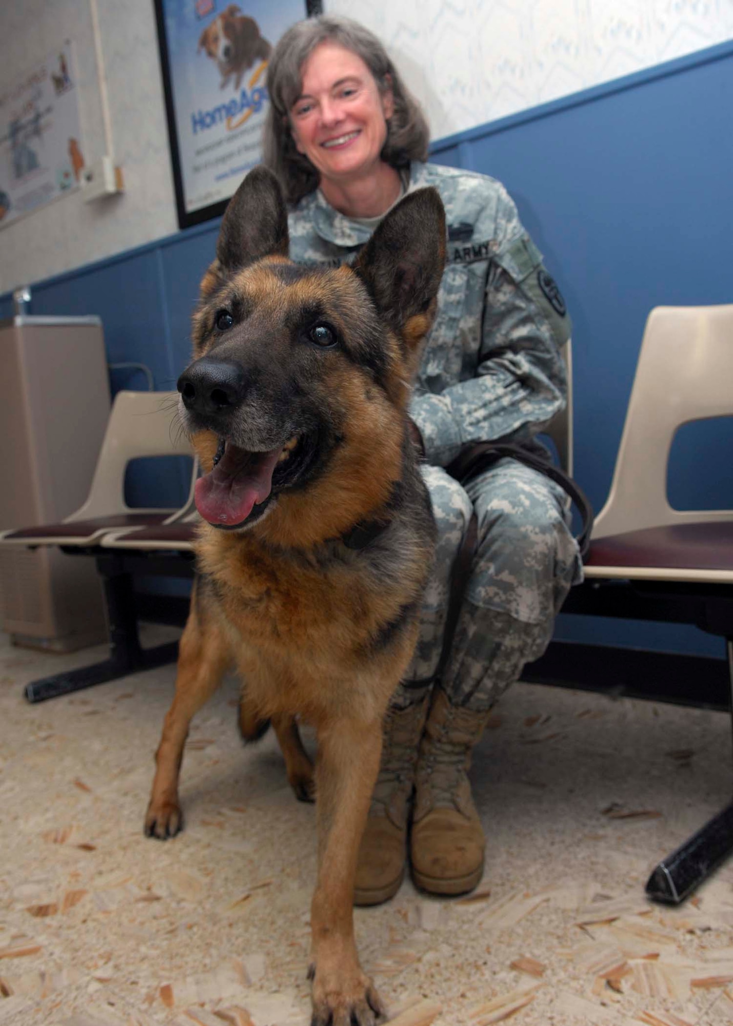 SHAW AIR FORCE BASE, S.C.-- Army Major Bonnie Martin, Fort Jackson Veterinarian Services chief, adopts Zeus, former 20th Security Forces Squadron military working dog, at the Shaw veterinary clinic Jan. 17. Zeus had to end his military service when his front right leg had to be amputated due to an accident.  (U.S. Air Force photo/A1C William Coleman)