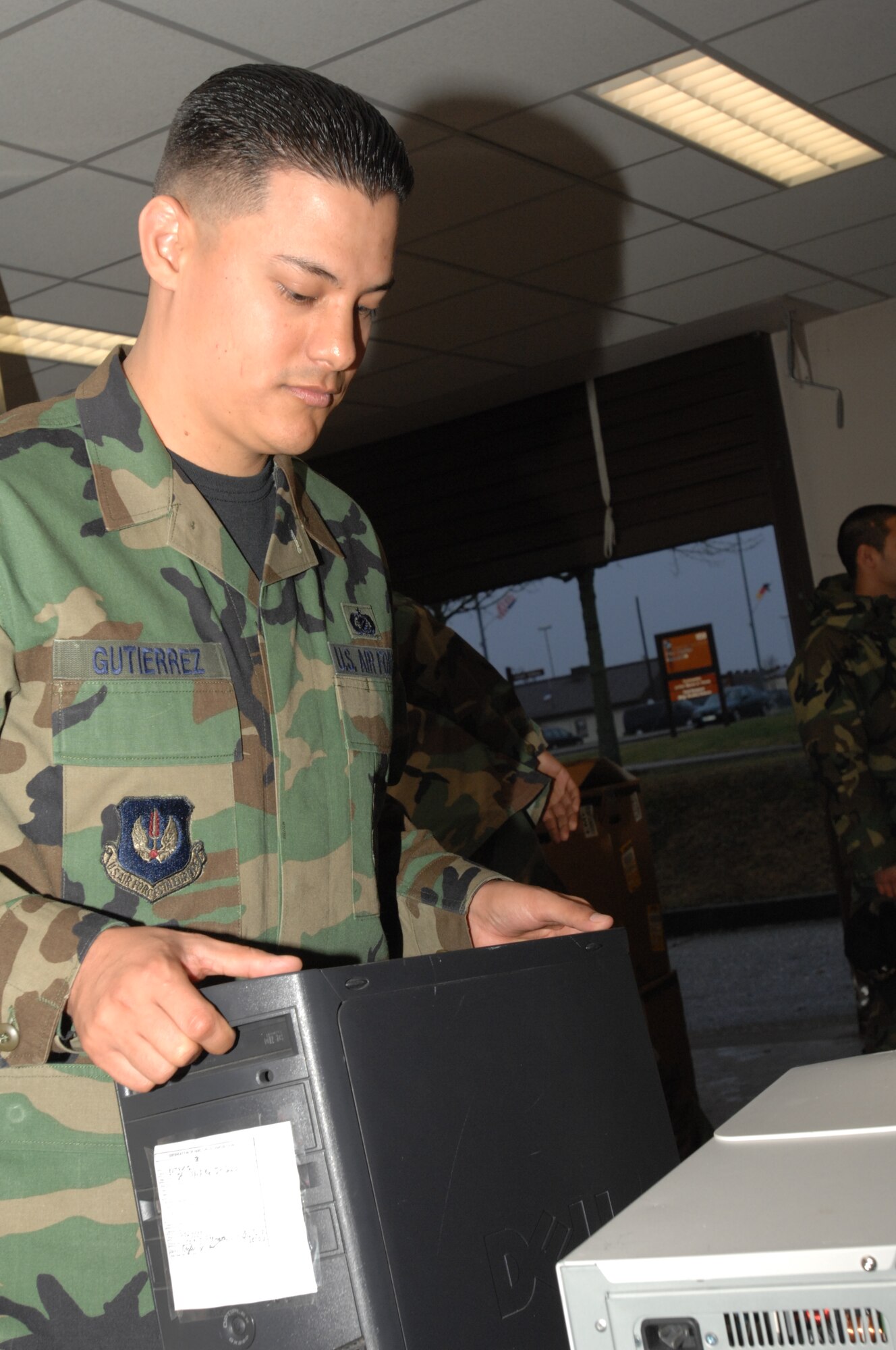 SPANGDAHLEM AIR BASE, Germany – Staff Sgt. Andres Gutierrez, 52nd Munitions Maintenance Group, sets a computer after preparing it to be taken to the Defense Reutilization Management Office. Sergeant Gutierrez is the 52nd MMG NCOIC of information management. (U.S. Air Force photo/Airman 1st Class Jenifer Calhoun)