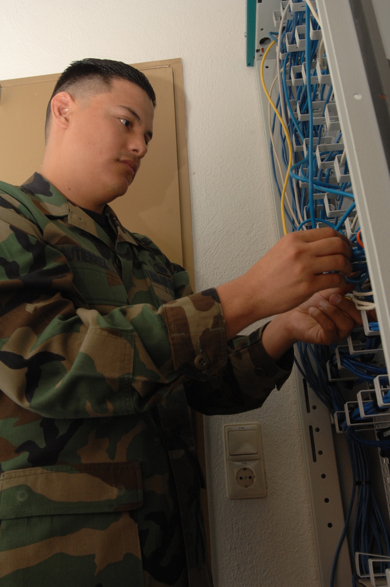 SPANGDAHLEM AIR BASE, Germany – Staff Sgt. Andres Gutierrez, 52nd Munitions Maintenance Group, works on a communications box Jan. 16, 2008. Sergeant Gutierrez manages hardware and software as well as performs configuration, management and initial diagnostics of information systems. (U.S. Air Force photo/Airman 1st Class Jenifer Calhoun)