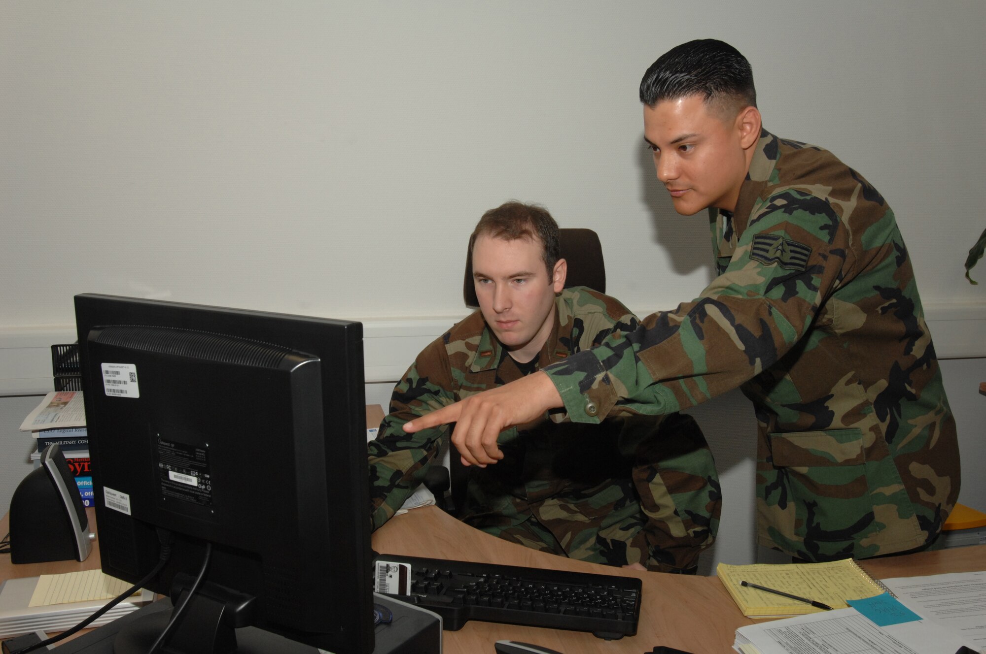 SPANGDAHLEM AIR BASE, Germany – Staff Sgt. Andres Gutierrez shows 2nd Lt. Perry Chaffee how to complete a form Jan. 16, 2008. Both Airmen are assigned to the 52nd Munitions Maintenance Group. (U.S. Air Force photo/Airman 1st Class Jenifer Calhoun)