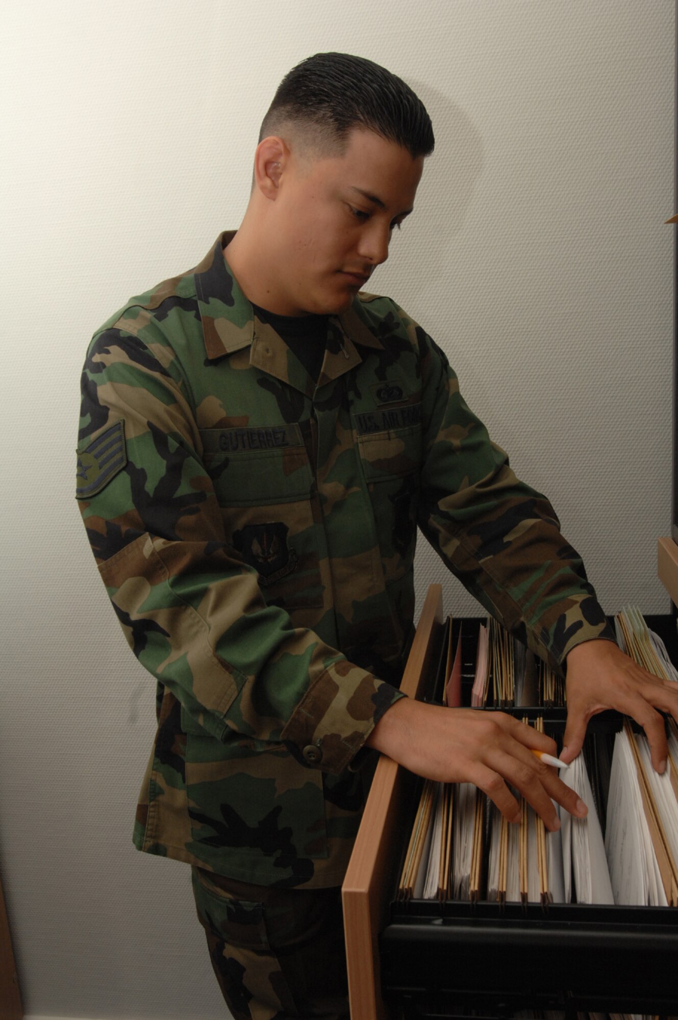SPANGDAHLEM AIR BASE, Germany – Staff Sgt. Andres Gutierrez, 52nd Munitions Maintenance Group, searches for files Jan. 16, 2008. Sergeant Gutierrez manages electronic and manual publications and forms development, design, control, storage and dissemination of forms for the 52nd MMG. (U.S. Air Force photo/Airman 1st Class Jenifer Calhoun)