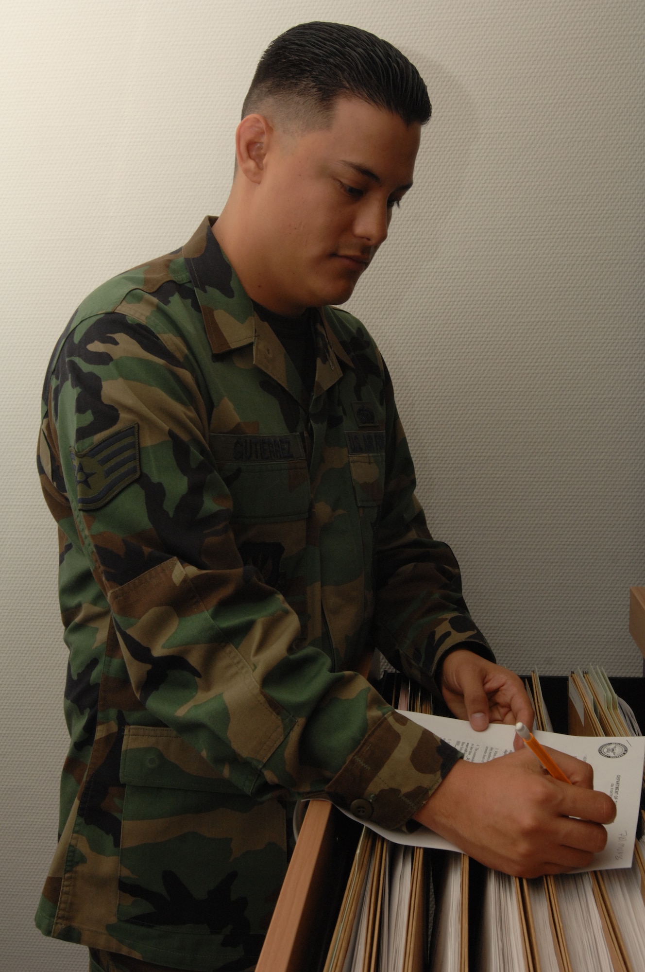 SPANGDAHLEM AIR BASE, Germany – Staff Sgt. Andres Gutierrez, 52nd Munitions Maintenance Group, fills out paper work Jan. 16, 2008. Sergeant Gutierrez is the NCOIC of information management for the 52nd MMG. (U.S. Air Force photo/Airman 1st Class Jenifer Calhoun)