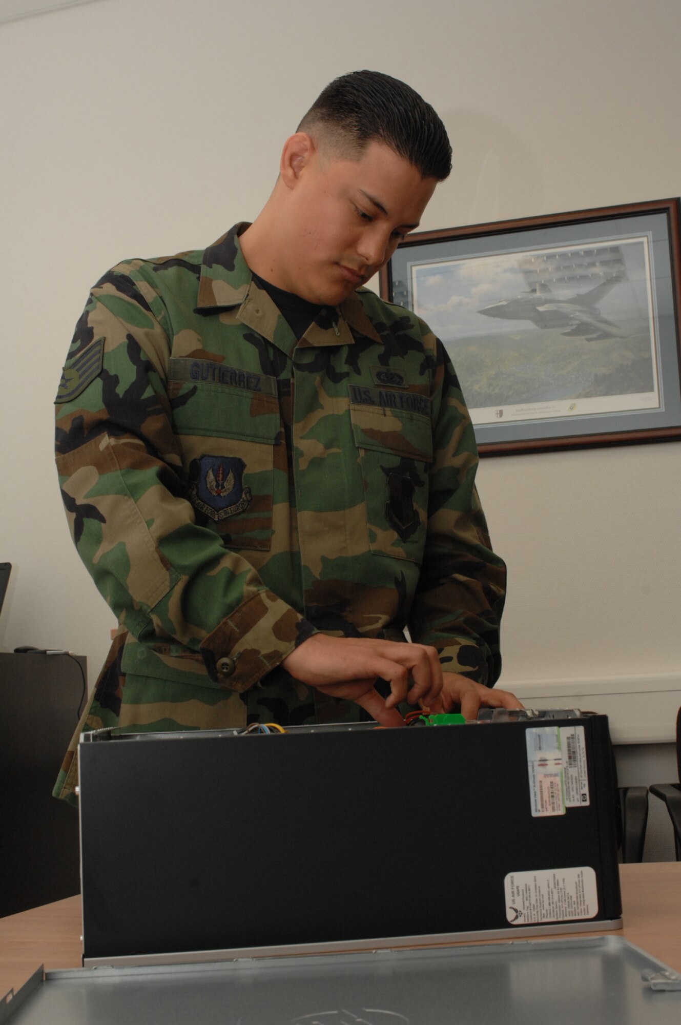 SPANGDAHLEM AIR BASE, Germany – Staff Sgt. Andres Gutierrez, 52nd Munitions Maintenance Group, trouble shoots a computer problem Jan. 16, 2008. Sergeant Gutierrez manages electronic and manual publications and forms development, design, control, storage and dissemination of forms for the 52nd MMG. (U.S. Air Force photo/Airman 1st Class Jenifer Calhoun)