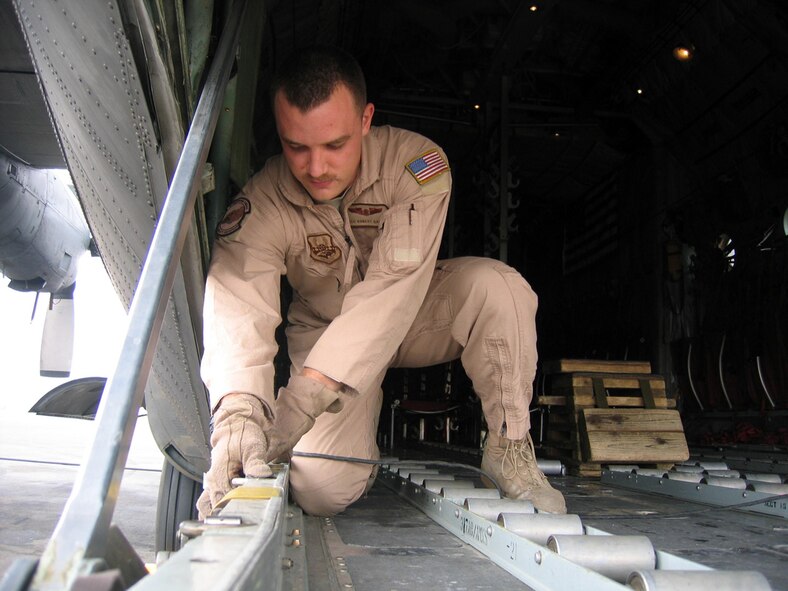 SOUTHWEST ASIA -- Airman 1st Class Robert Gantz, 40th Expeditionary Airlift Squadron loadmaster deployed from Dyess Air Force Base, Texas, performs a pre-flight operation check on the ramp locks of a C-130 Hercules here. Loadmasters must ensure these locks are operational before every flight to keep the pallates and cargo secure. (U.S. Air Force photo by Senior Airman Carolyn Viss)