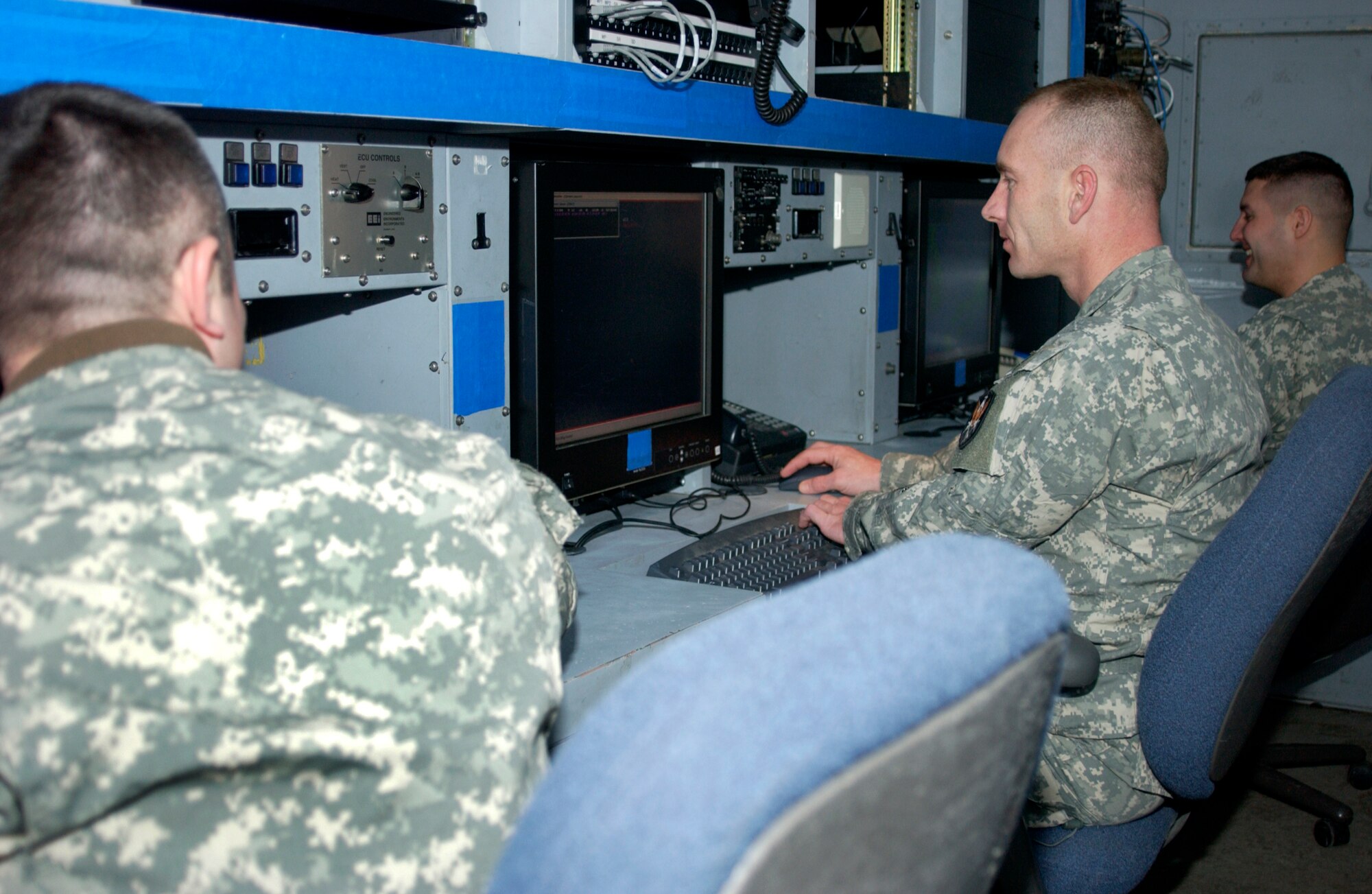 MISAWA AIR BASE, Japan -- Army Spc. John Dempsey, Sgt. 1st Class Cody Dorman and Staff Sgt. Greg Irvine demonstrate a response to a simulated missile launch at the Joint Tactical Ground Station here on Jan. 22, 2008. JTAGS is operated by approximately 24 people, 24 hours a day, seven days a week. (U.S. Air Force photo by Airman 1st Class Eric Harris)