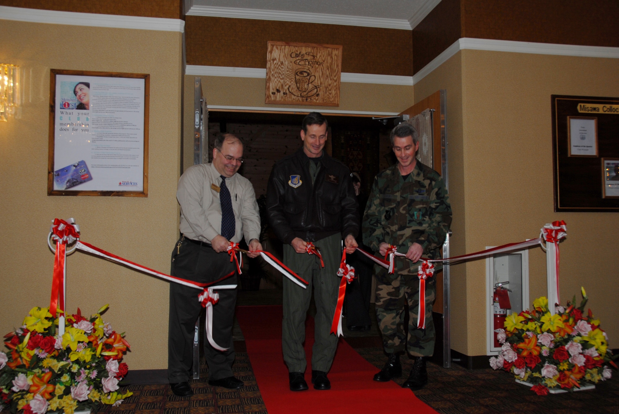 MISAWA AIR BASE, Japan -- Dennis Hansard, Collocated Club General Manager, Col. T.J. O'Shaughnessy, 35th Fighter Wing commander, and Col. Mark Burns, 35th Mission Support Group commander, cut the ribbon during the grand opening of Cafe Aomori, here Jan 22, 2008.  The Cafe Aomori project began in August 2007 with the Services Squadron investing approximately $50,000 in renovations of the Aomori Lounge in order to bring Starbucks here.  (U.S. Air Force photo by Senior Airman Laura R. McFarlane)