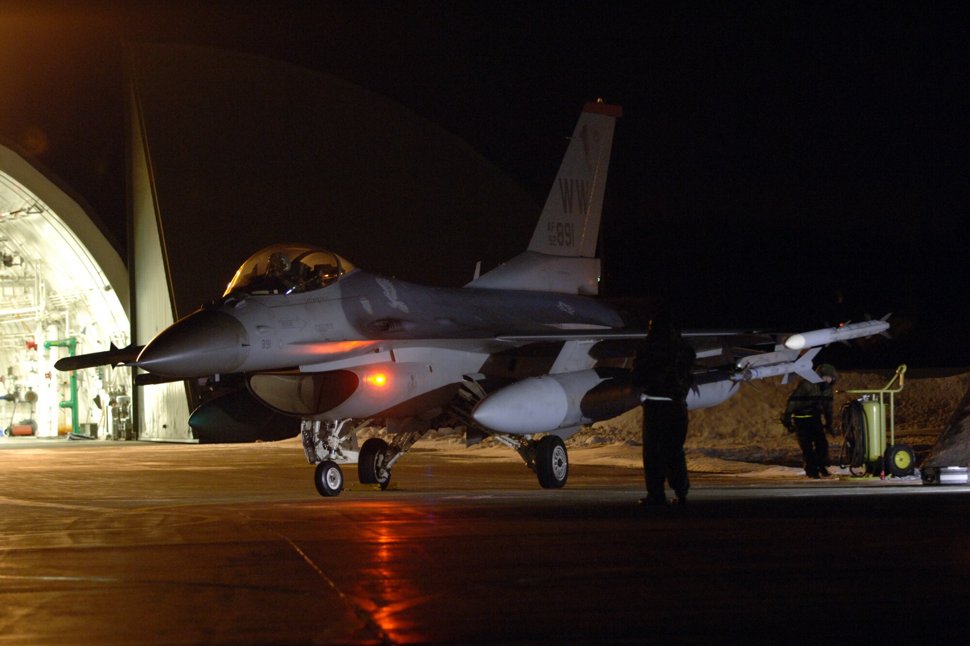 MISAWA AIR BASE, Japan -- 13th Aircraft Maintenance Unit crew chiefs prep an F-16 Fighting Falcon for takeoff early Jan. 18, 2008. Members of the 13th FS were headed to Eglin Air Force Base, Fla., to participate in exercise Combat Hammer. (U.S. Air Force photo by Chief Master Sgt. Michael Atkinson)