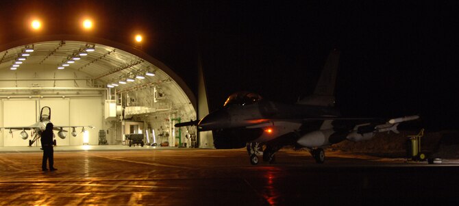 MISAWA AIR BASE, Japan -- A 13th Aircraft Maintenance Unit crew chief helps prepare an F-16 Fighting Falcon for takeoff during the early morning hours Jan. 18, 2008. Members of the 13th Fighter Squadron were headed to Eglin Air Force Base, Fla., to participate in the Combat Hammer weapons system evaluation program. (U.S. Air Force photo by Chief Master Sgt. Michael Atkinson)
