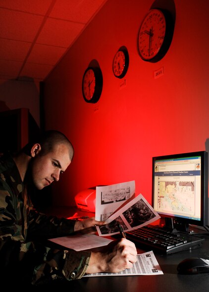 Airman Joseph Newlon, 24, from Keokuk, Iowa, reviews significant weather depictions from the 17th Operational Weather Squadron at Hickam Air Force Base, Hawaii. Newlon is a broadcast weather technician at the American Forces Network Weather Center on Offutt Air Force Base, Neb. (Photo by G. A. Volb)