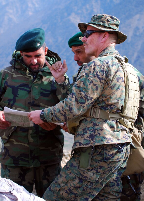 Marine Lt. Col. James F. Werth (front right), Afghan National Army Lt. Col. Mohammad Naseem (left), and Afghan Capt. Mohammad Usman Amoni discuss operational tactics in the eastern Afghanistan mountains. Werth is the team officer in charge for Embedded Training Team 7-2, which is deployed to Afghanistan from Okinawa, Japan, to work with the ANA. Naseem is commander of 3rd Kandak (Armored), 3rd Brigade, 201st ANA Corps, and Amoni is company commander for Headquarters and Headquarters Company, 3rd Kandak (Armored). Photo by Staff Sgt. Luis P. Valdespino Jr., USMC