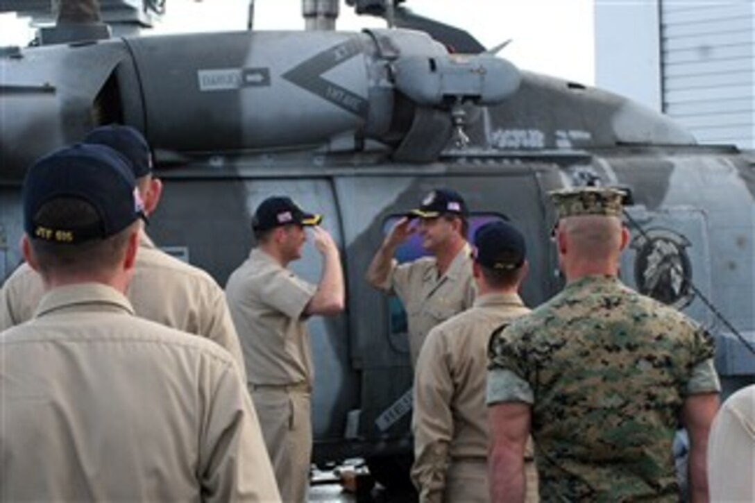U.S. Navy Capt. Brad Smith assumes command of a task group from Capt. William Sheehan during a change of command ceremony Jan. 20, 2008, aboard the USNS Stockham in port in Puerto Princesa, Republic of the Philippines.  