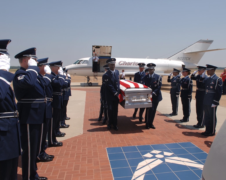 The base Honor Guard helped the BLAZE Team pay tribute to Staff Sgt. John Self, a Mississippi native killed in Iraq, as they bring his remains from the aircraft to a waiting hearse. Sergeant Self was stationed at Little Rock AFB, Ark. BLAZE Team members lined the one-mile route from the flightline to the main gate as they paid tribute to the recently fallen Airman and his family. (U.S. Air Force photo)
