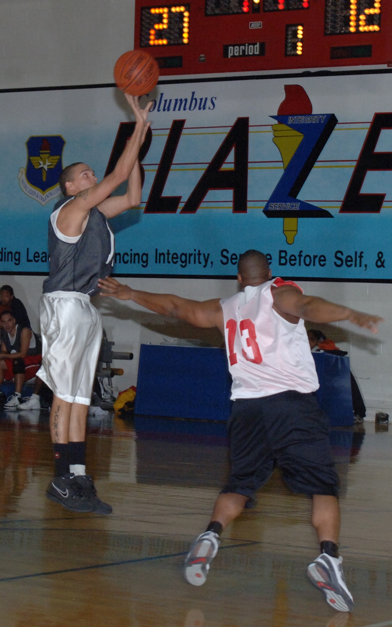 Airman Bryant Johanson, 14th Medical Group, shots a jumper from the foul line as a member of the 14th Operations Support Suqadron defends him in intramural basketball action Wednesday night at the Fitness Center. The 14th MDG was victorious over the 14th OSS by a score of 67 to 40. (U.S. Air Force photo by Airman 1st Class Danielle Hill)
