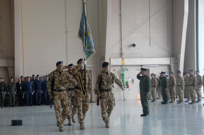 CREECH AIR FORCE BASE, Nev.— Flight Lt. Bert Weedon, Flag bearer, Royal Air Force of Great Britain, along with honor guard members, presents the 39th United Kingdom Reaper Squadron Colors during an activation ceremony here Jan. 23. (U.S. Air Force photo by Staff Sgt. Scottie McCord)