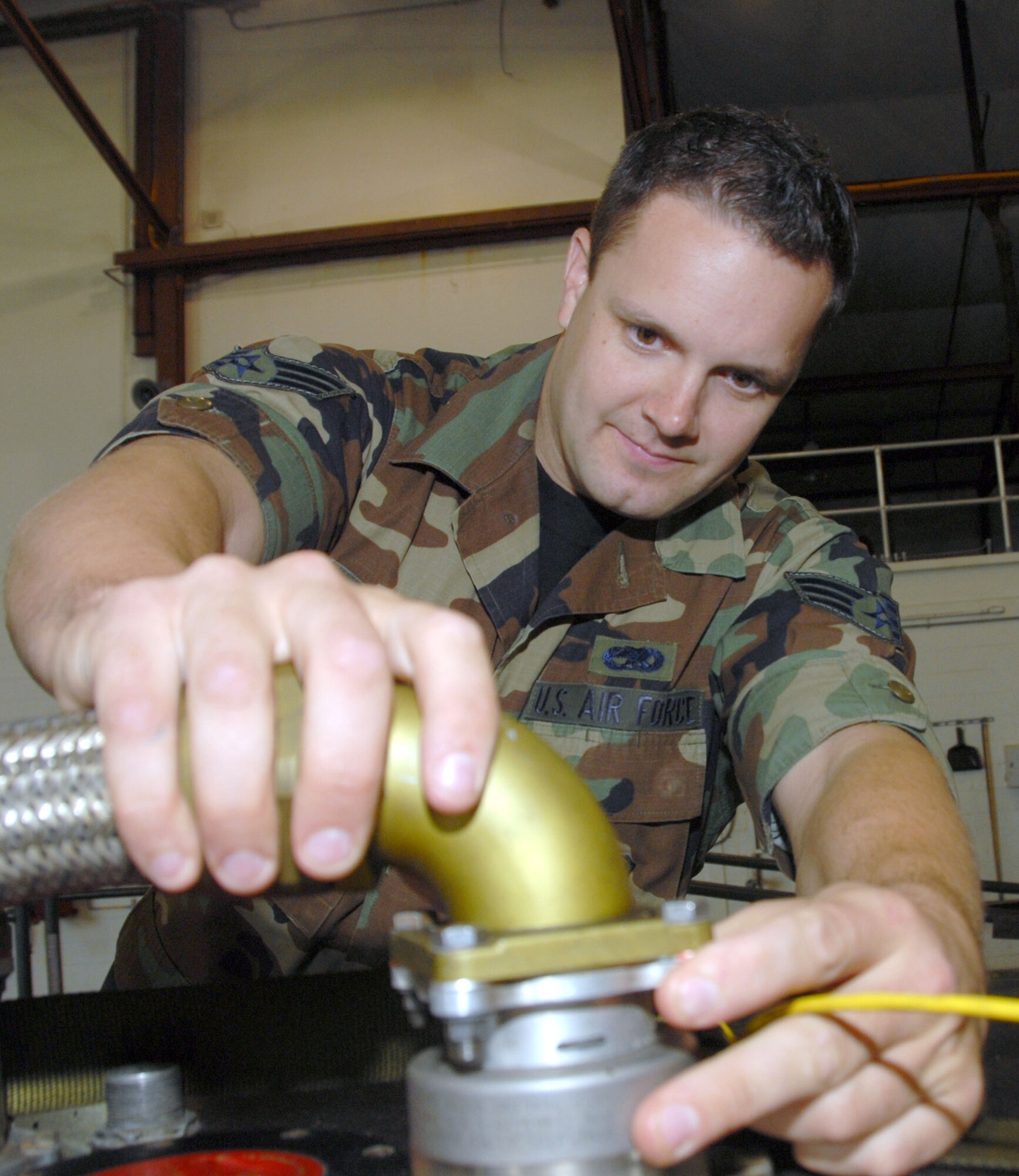 Senior Airman Luke Borlee, an Air Force Reservist with the 920th Maintenance Squadron, Patrick Air Force Base, Fla., inspects the couplings on the fuel line of an HH-60 Pave Hawk helicopter auxillary fuel control package. (U.S. Air Force Photo/Master Sgt. Chance C. Babin)