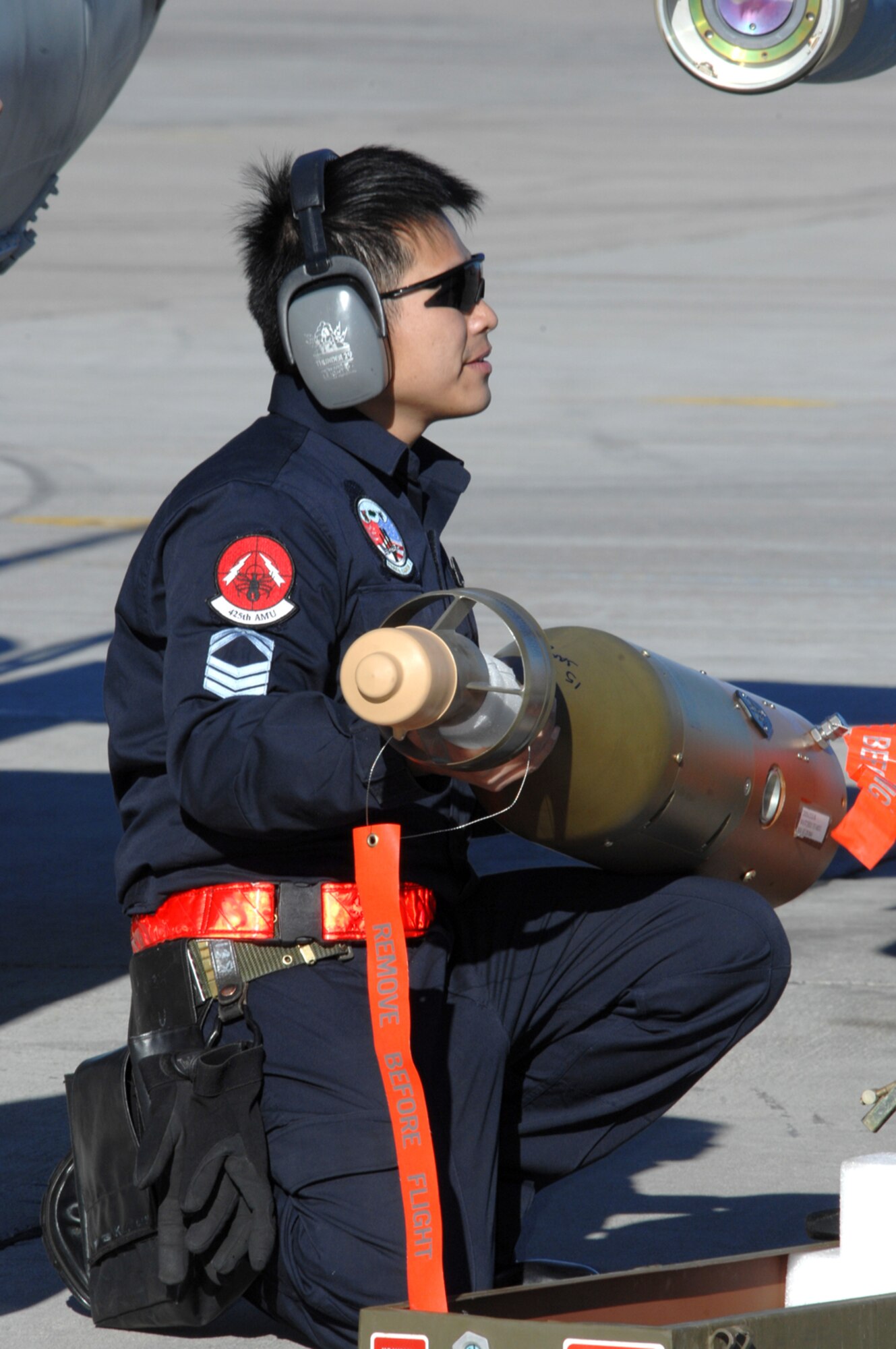 NELLIS AIR FORCE BASE, Nev.— Republic of Singapore air force member 1SG Kito Kwok Keong, 425th Aircraft Maintenance Unit, Luke Base, Ariz., prepares to attach munitions to an aircraft here Jan. 17. The 425th AMU is currently at Nellis participating in Red Flag 8-2.1, which is a multi-national exercise providing pilots with a realistic environment to practice combat scenarios. The experience gained during the exercise is vital to the survival of pilots in combat. The unit is assigned to Luke AFB for specialized training on their F-16 aircraft they can only receive in the U.S. (U.S. Air Force photo by Senior Airman Nadine Y. Barclay)