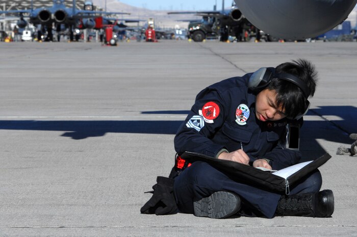 NELLIS AIR FORCE BASE, Nev.— Republic of Singapore air force member SSG Oswin Yean, 425th Aircraft Maintenance Unit, Luke Base, Ariz., annotates aircraft maintenance here Jan. 17. The 425th AMU is currently at Nellis participating in Red Flag 8-2.1, which is a multi-national exercise providing pilots with a realistic environment to practice combat scenarios. The experience gained during the exercise is vital to the survival of pilots in combat. The unit is assigned to Luke AFB for specialized training on their F-16 aircraft they can only receive in the U.S. (U.S. Air Force photo by Senior Airman Nadine Y. Barclay)