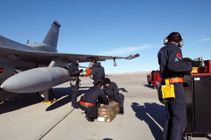 NELLIS AIR FORCE BASE, Nev.—Members of the Republic of Singapore air force, 425th Aircraft Maintenance Unit, Luke AFB, Ariz., perform pre-flight maintenance on their aircraft before a mission here Jan. 17. The 425th AMU is currently at Nellis participating in Red Flag 8-2.1, which is a multi-national exercise providing pilots with a realistic environment to practice combat scenarios. The experience gained during the exercise is vital to the survival of pilots in combat. The unit is assigned to Luke AFB for specialized training on their F-16 aircraft they can only receive in the U.S. (U.S. Air Force photo by Master Sgt. Robert W. Valenca)