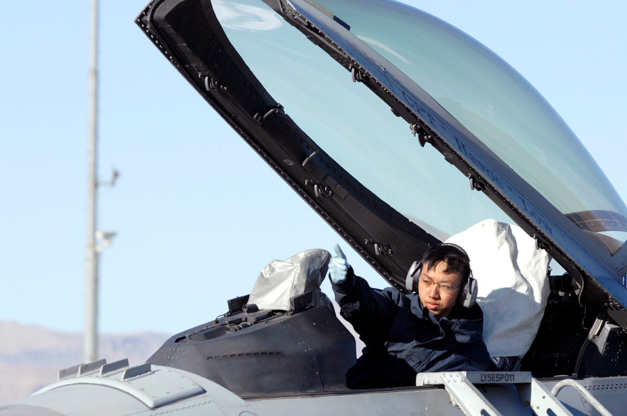 NELLIS AIR FORCE BASE, Nev.—Republic of Singapore air force member 1SG Lee Kian Chye, 425th Aircraft Maintenance Unit, Luke AFB, Ariz., gives a thumbs up during an engine run-up check here Jan. 17. The 425th AMU is currently at Nellis participating in Red Flag 8-2.1, which is a multi-national exercise providing pilots with a realistic environment to practice combat scenarios. The experience gained during the exercise is vital to the survival of pilots in combat. The unit is assigned to Luke AFB for specialized training on their F-16 aircraft they can only receive in the U.S. (U.S. Air Force photo by Master Sgt. Robert W. Valenca)