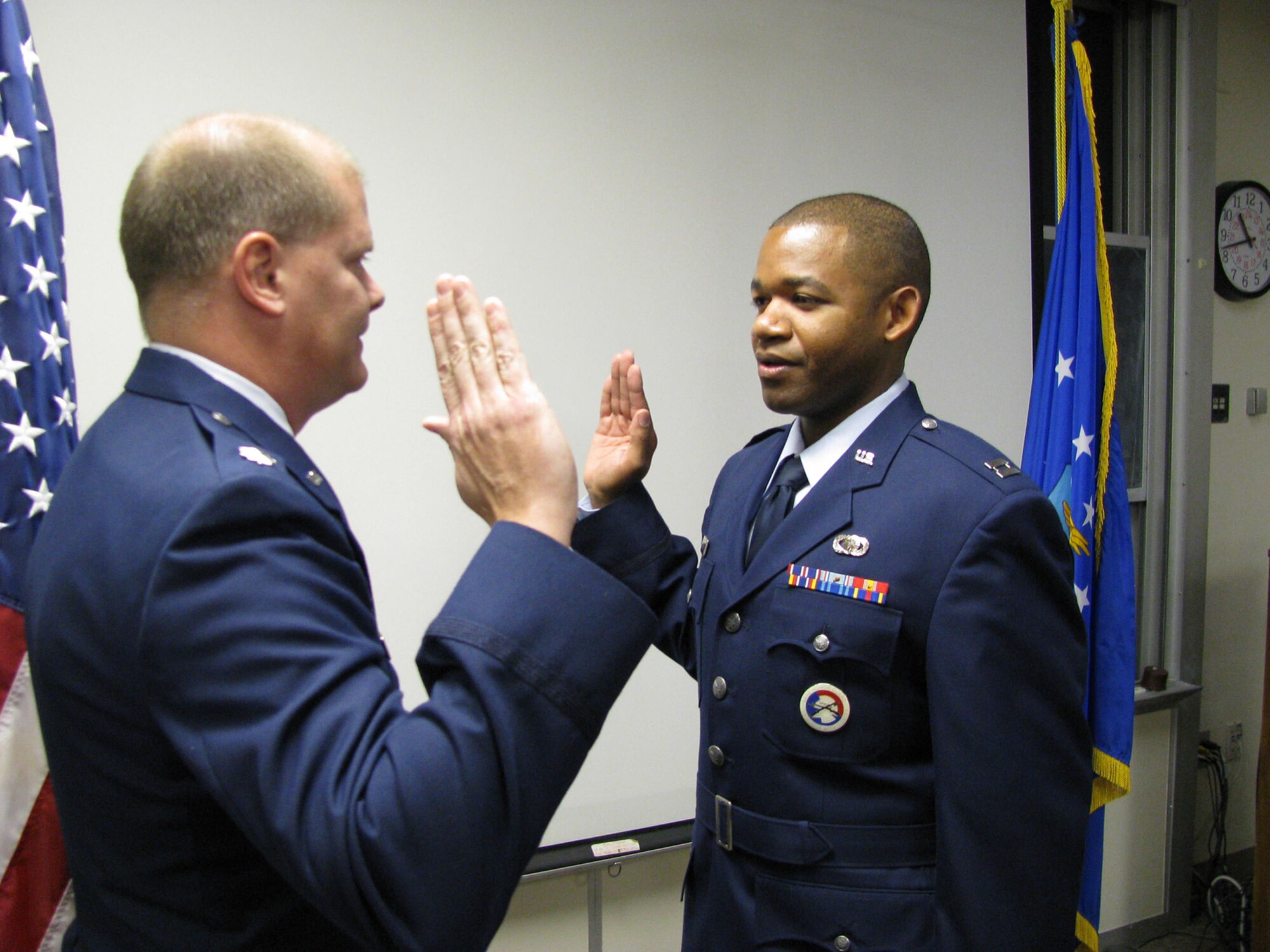 Capt. Jonathan Pellum recites the oath of office I a ceremony officiated by Lt. Col. Gary Salmons here. The captain used his promotion ceremony to showcase the proposed Air Force Heritage Service Dress Coat. Captain Pellum is the heritage coat program manager, 648th Aeronautical Systems Squadron at Brooks-City Base, Texas. (U.S. Air Force photo)