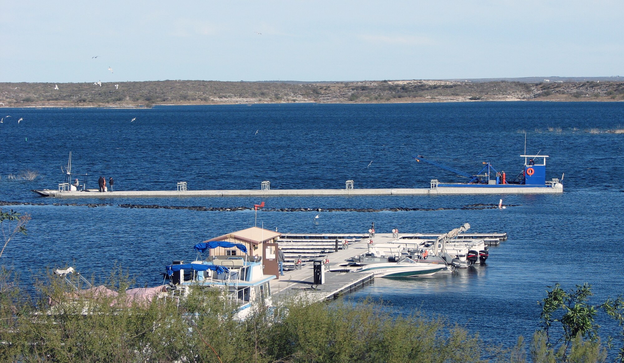 LAUGHLIN AIR FORCE BASE, Texas—Fifteen anchors, each weighing 7,500 pounds, were used by the contractors to join the pieces of the breakwater system together and secure it into place Jan. 10.  The new breakwater is anchored approximately 20 feet from the west bank of the marina, and spans 180 feet.  (U.S. Air Force photo by Mike Easterly)