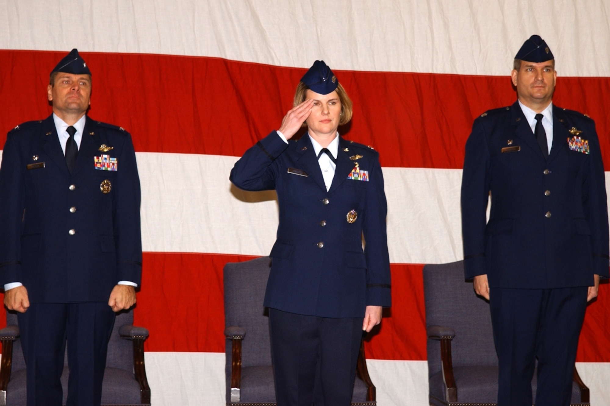 Lieutenant Col. Kelly Menozzi, 48th Flying Training Squadron commander, salutes her new squadron members during the Change of Command ceremony Jan 17 as Colonel Eric Theisen, 14th Operations Group commander, and Lt. Col. David Hammack, former 48th FTS commander, look on. (U.S. Air Force photo) 
