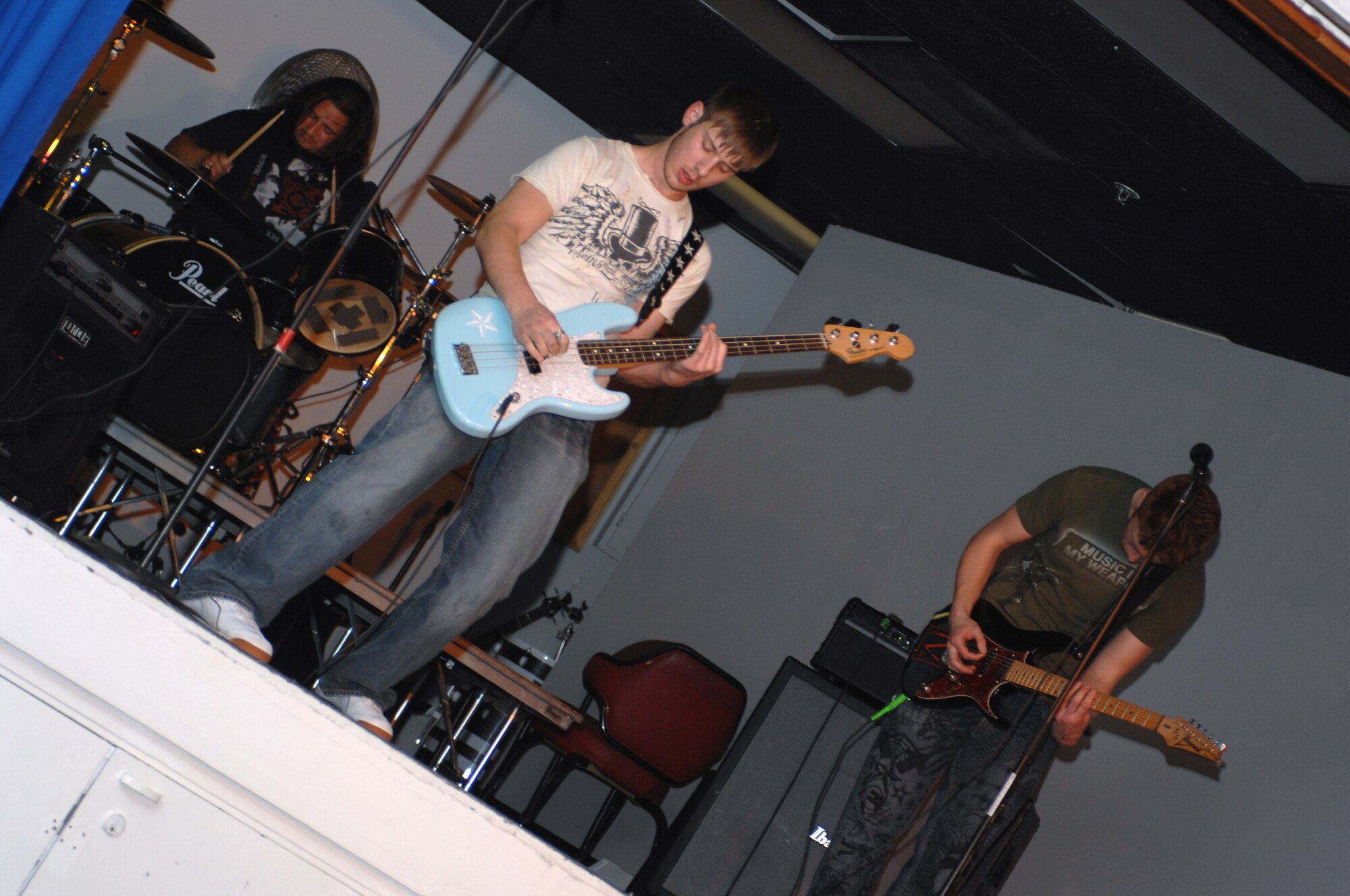 CANNON AIR FORCE BASE, N.M. - (left to right) Taylor Borden, Jim Bailey and Zach Grizon, also known as Cause and Effect, play in the battle of the bands at the End Zone Jan. 18. Their band took first place, making it their third win in a row at the battle of the bands. (U.S. Air Force photo by Airman 1st Class Evelyn Chavez)