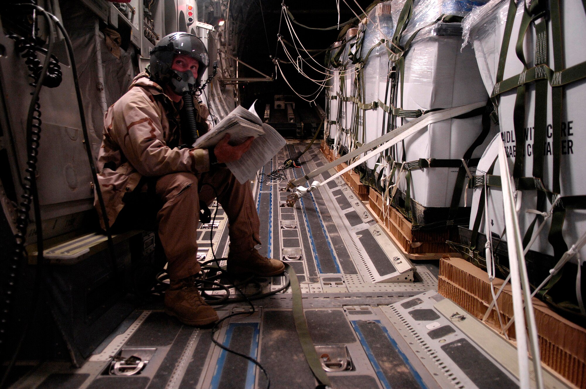Staff Sgt. Chris Koch reviews the checklist on a C-17 Globemaster III for a Joint Precision Airdrop Delivery System of 40 bundles of humanitarian supplies to a drop zone Jan. 14 in Afghanistan. Sergeant Kock is a loadmaster from the 17th Airlift Squadron from Charleston Air Force Base, S.C., and is deployed to the 816th Expeditionary Airlift Squadron in Southwest Asia. (U.S. Air Force photo/Master Sgt. Andy Dunaway) 
