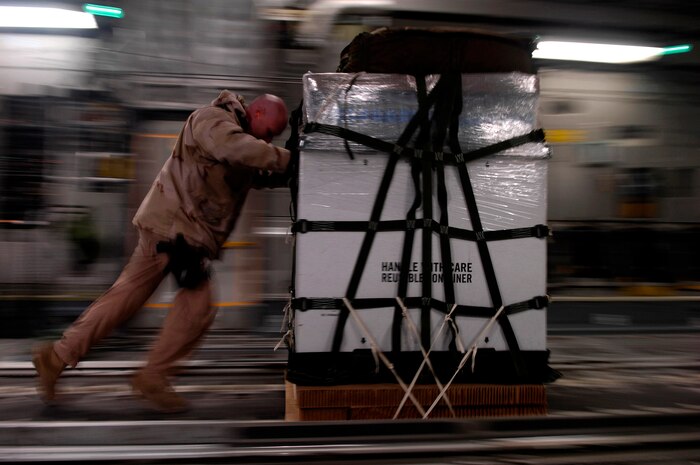 Staff Sgt. Chris Koch loads one of 40 bundles on a C-17 Globemaster III for a Joint Precision Airdrop Delivery System of 40 bundles of humanitarian supplies to a drop zone Jan. 14 in Afghanistan. Sergeant Kock is a loadmaster from the 17th Airlift Squadron from Charleston Air Force Base, S.C., and is deployed to the 816th Expeditionary Airlift Squadron in Southwest Asia. (U.S. Air Force photo/Master Sgt. Andy Dunaway) 

