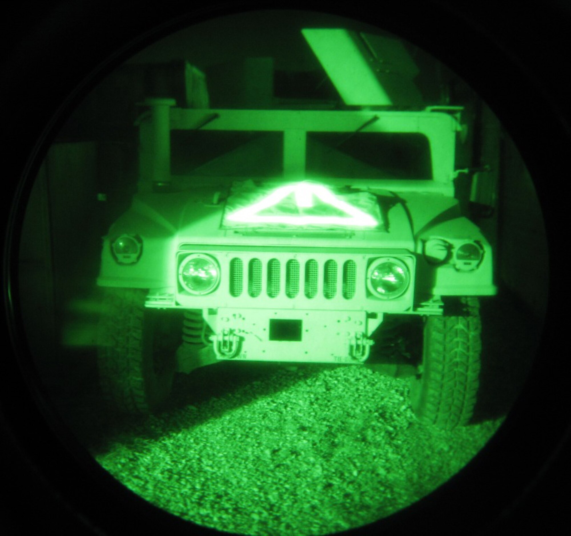 A military vehicle marked with TRON I (small strip in the center) and TRON III is shown through night vision googles. The identification technology was developed by Air Force Research Laboratory in collaboration with industry to support joint warfighters.  (U.S. Air Force photo)