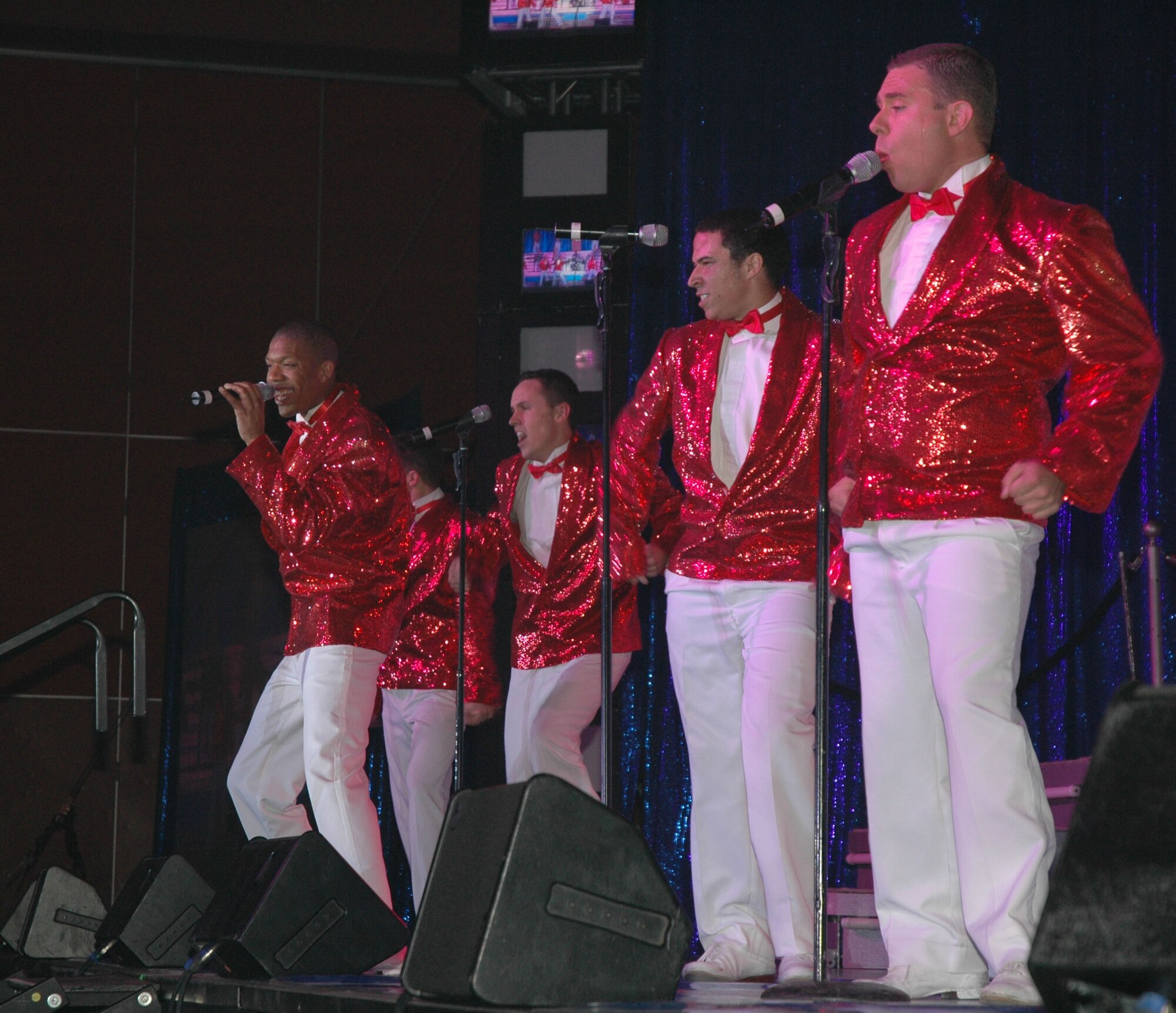 Members of Tops in Blue sing during their 142nd performance this year at the Four Season's Arena Jan. 22. Tops in Blue is an all active-duty U.S. Air Force special unit comprised of 28 members picked for their talents in entertaining. The group sets up their own equipment weighing in at about 60,000 pounds and performs at 160 locations per year including deployed locations such as Afghanistan and Kyrgyzstan. This year's theme is The Fly-By, commemorating the Air Force's 60th Anniversary. (U.S. Air Force photo/Airman 1st Class Dillon White)