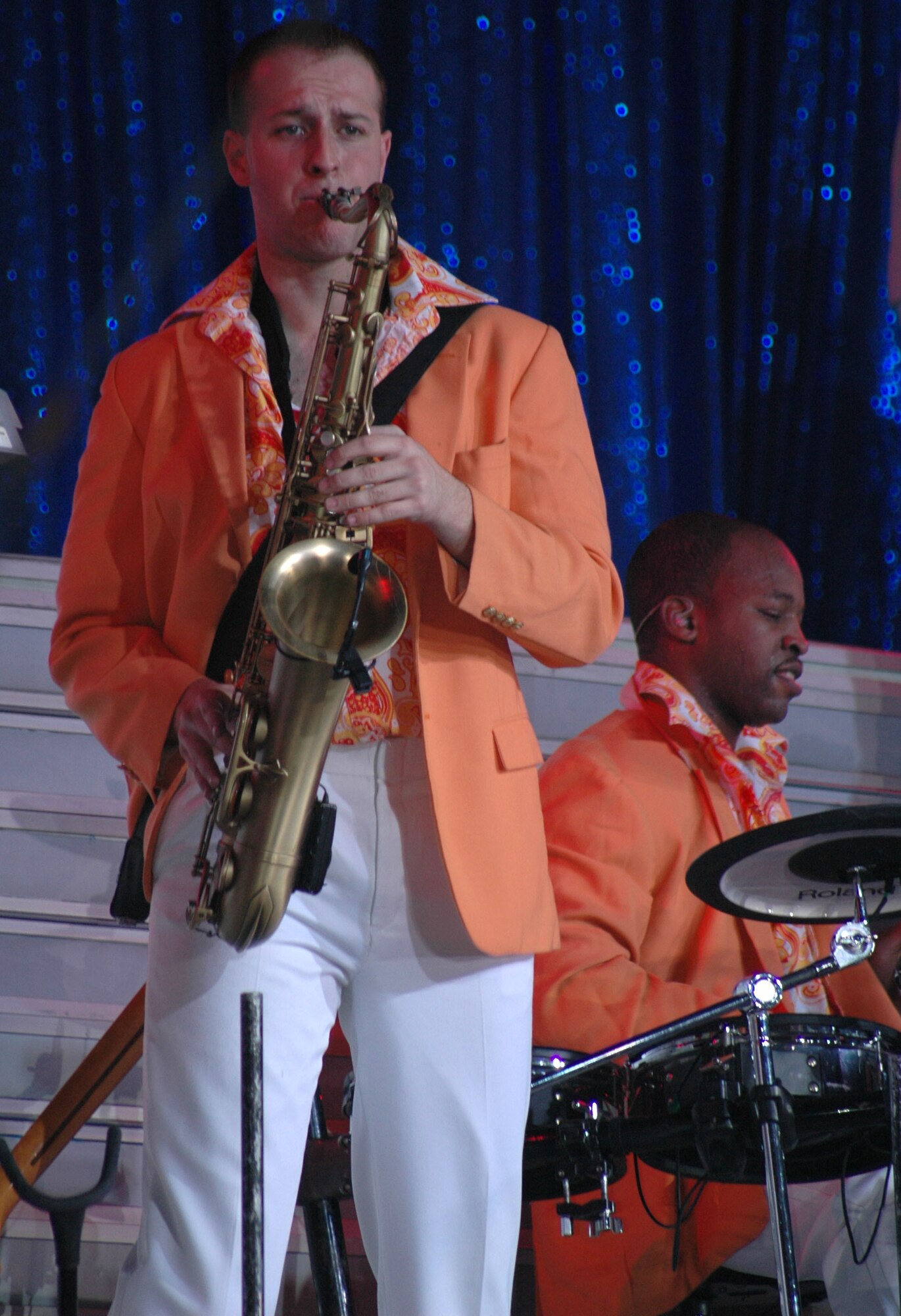 Senior Airman Jeremiah Smith, Tops in Blue performer, plays the saxophone during the group's 142nd performance this year at the Four Season's Arena Jan. 22. Tops in Blue is an all active-duty U.S. Air Force special unit comprised of 28 members picked for their talents in entertaining. The group sets up their own equipment weighing in at about 60,000 pounds and performs at 160 locations per year including deployed locations such as Afghanistan and Kyrgyzstan. This year's theme is “The Fly-By”, commemorating the Air Force's 60th Anniversary. (U.S. Air Force photo/Airman 1st Class Dillon White)