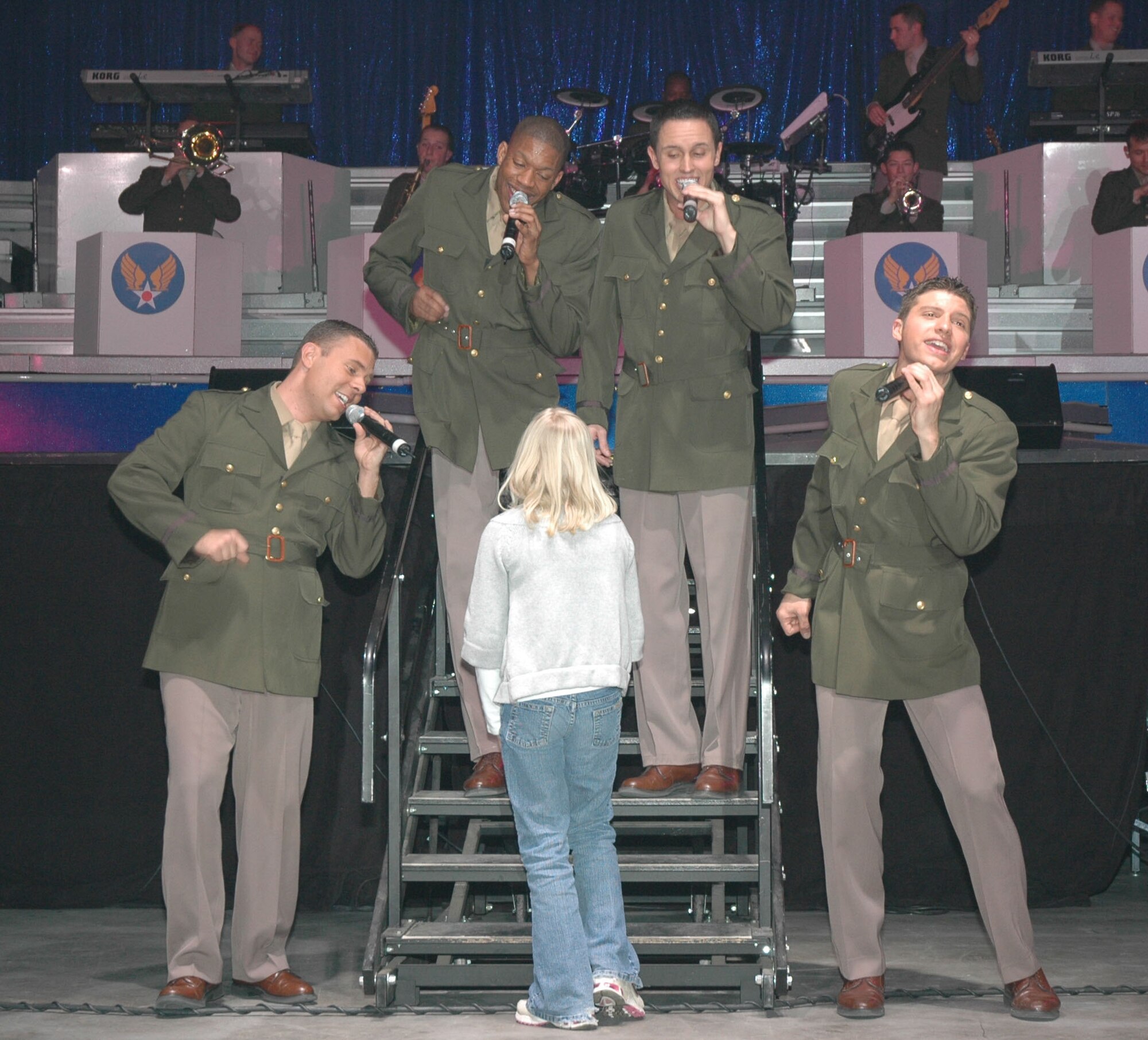 Senior Airman Nicholas Amari, Tops in Blue performer, sings during a performance at the Four Season's Arena Jan. 22. Tops in Blue is an all active-duty U.S. Air Force special unit comprised of 28 members picked for their talents in entertaining. The group sets up their own equipment weighing in at about 60,000 pounds and performs at 160 locations per year including deployed locations such as Afghanistan and Kyrgyzstan. This year's theme is "The Fly-By", commemorating the Air Force's 60th Anniversary. (U.S. Air Force photo/Airman 1st Class Dillon White)
